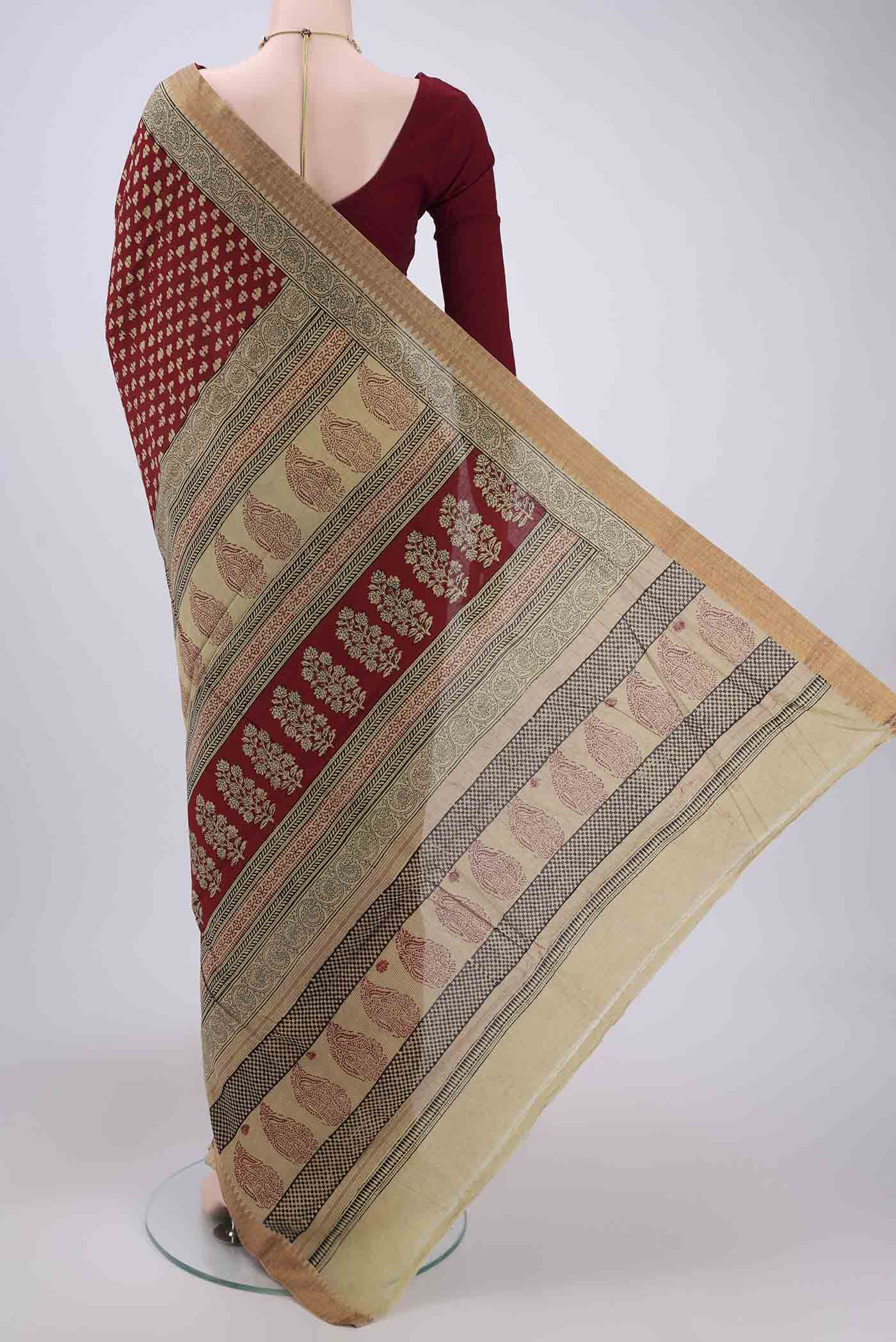 Flat view of Maroon Maheshwari Silk Cotton Saree with Stripes on the body and Zari Border. 
