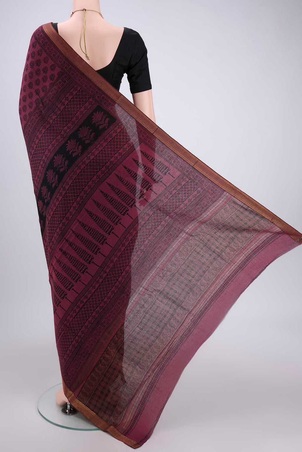 Flat view of Light Magenta Maheshwari Silk Cotton Saree with Batik Print on the body and Zari Border. 