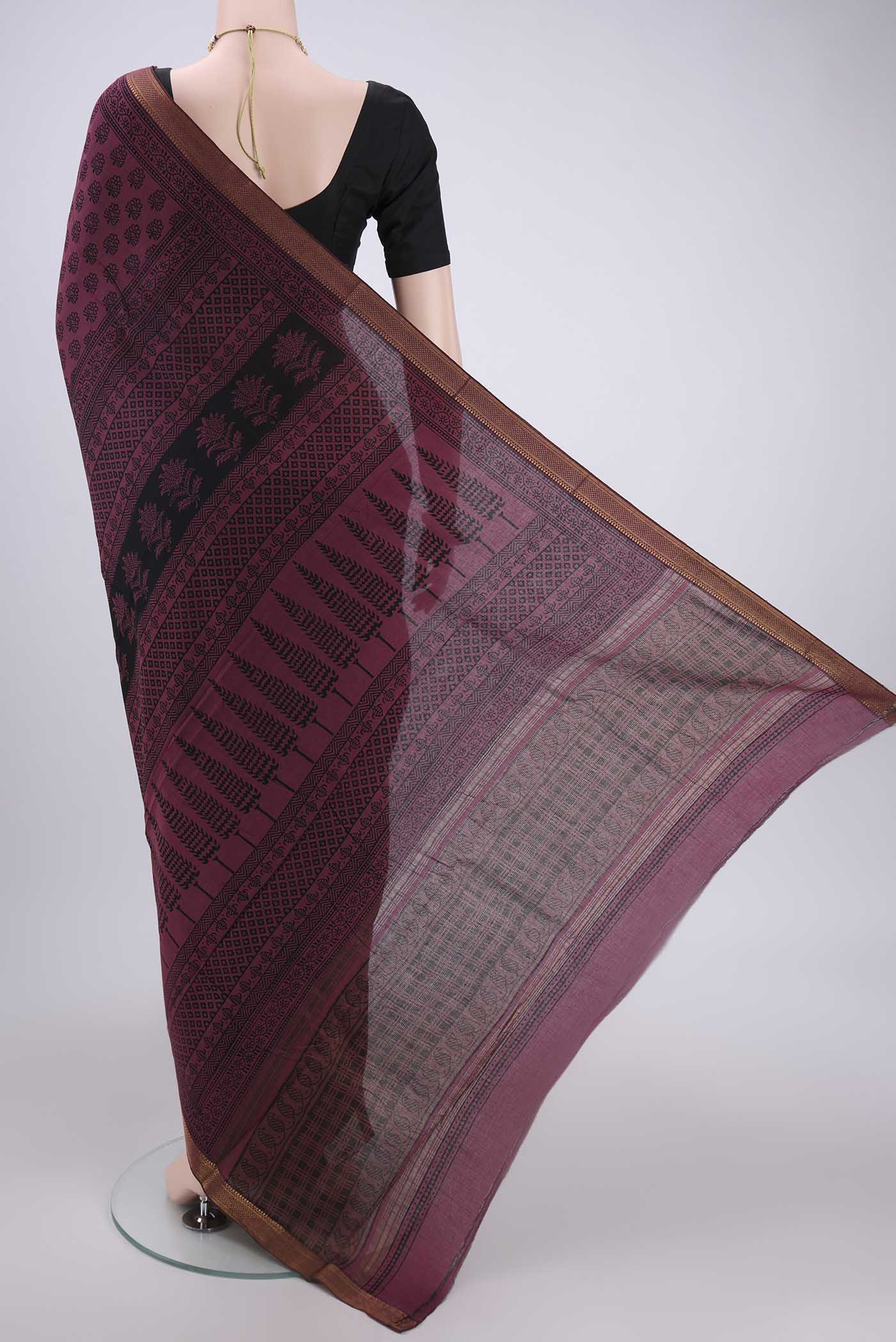 Flat view of Light Magenta Maheshwari Silk Cotton Saree with Batik Print on the body and Zari Border. 