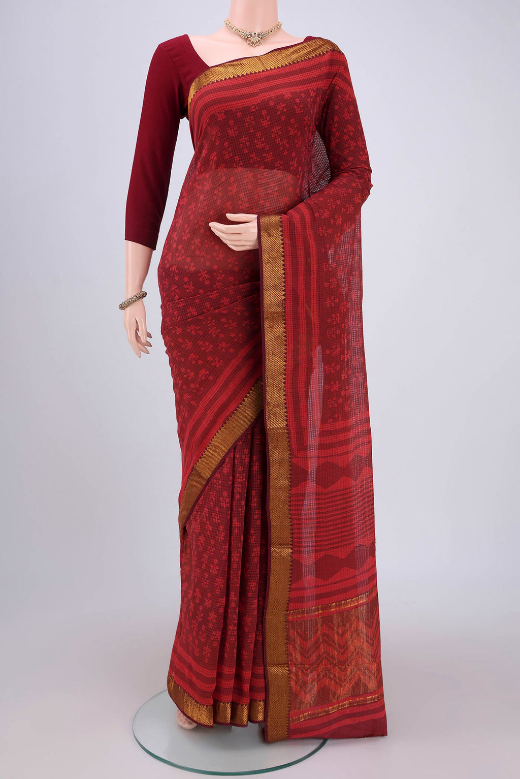 Red Maheshwari Silk Cotton Saree with Batik Print on the body and Zari Border.  displayed on a mannequin
