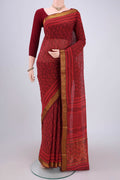 Red Maheshwari Silk Cotton Saree with Batik Print on the body and Zari Border.  displayed on a mannequin