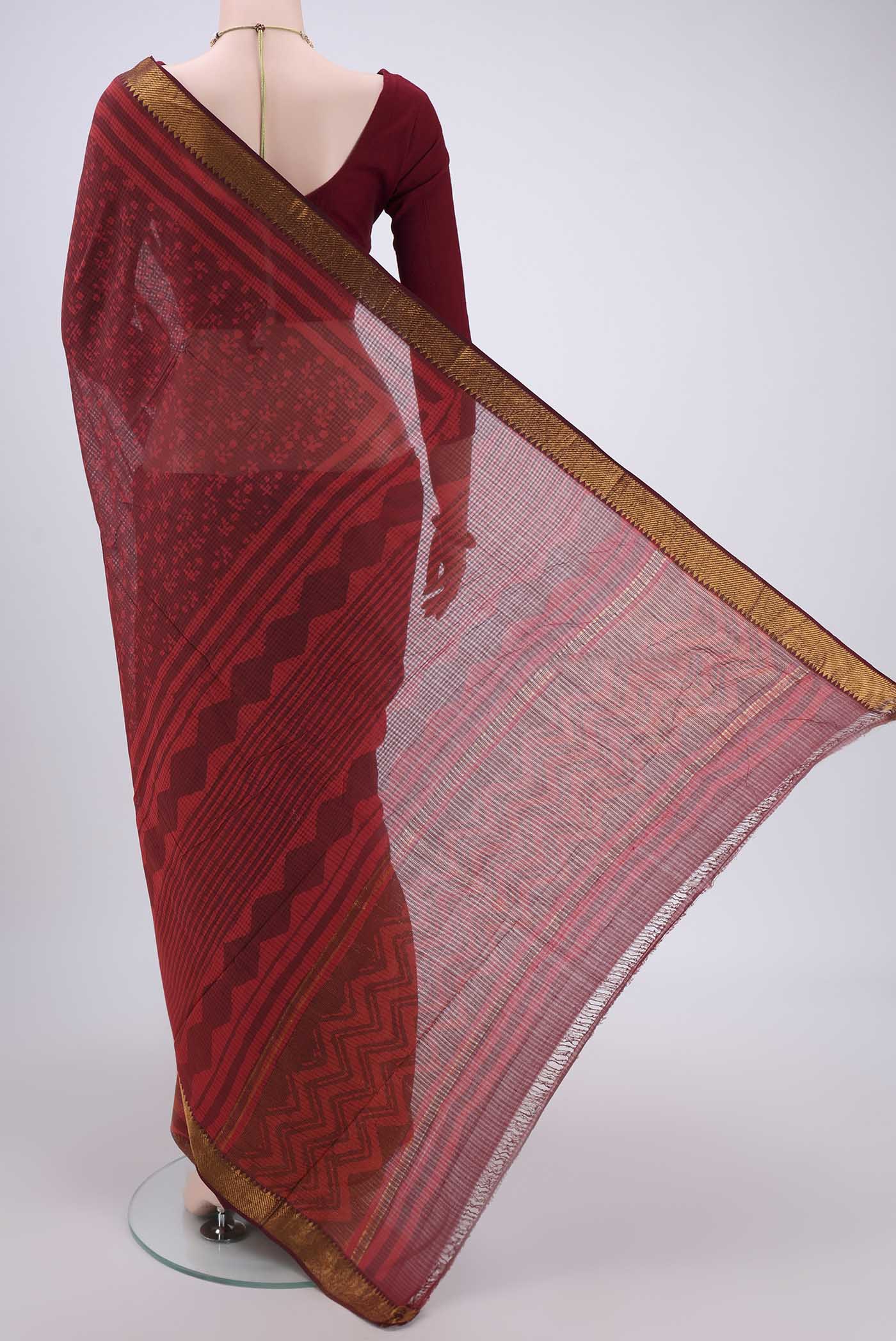 Flat view of Red Maheshwari Silk Cotton Saree with Batik Print on the body and Zari Border. 