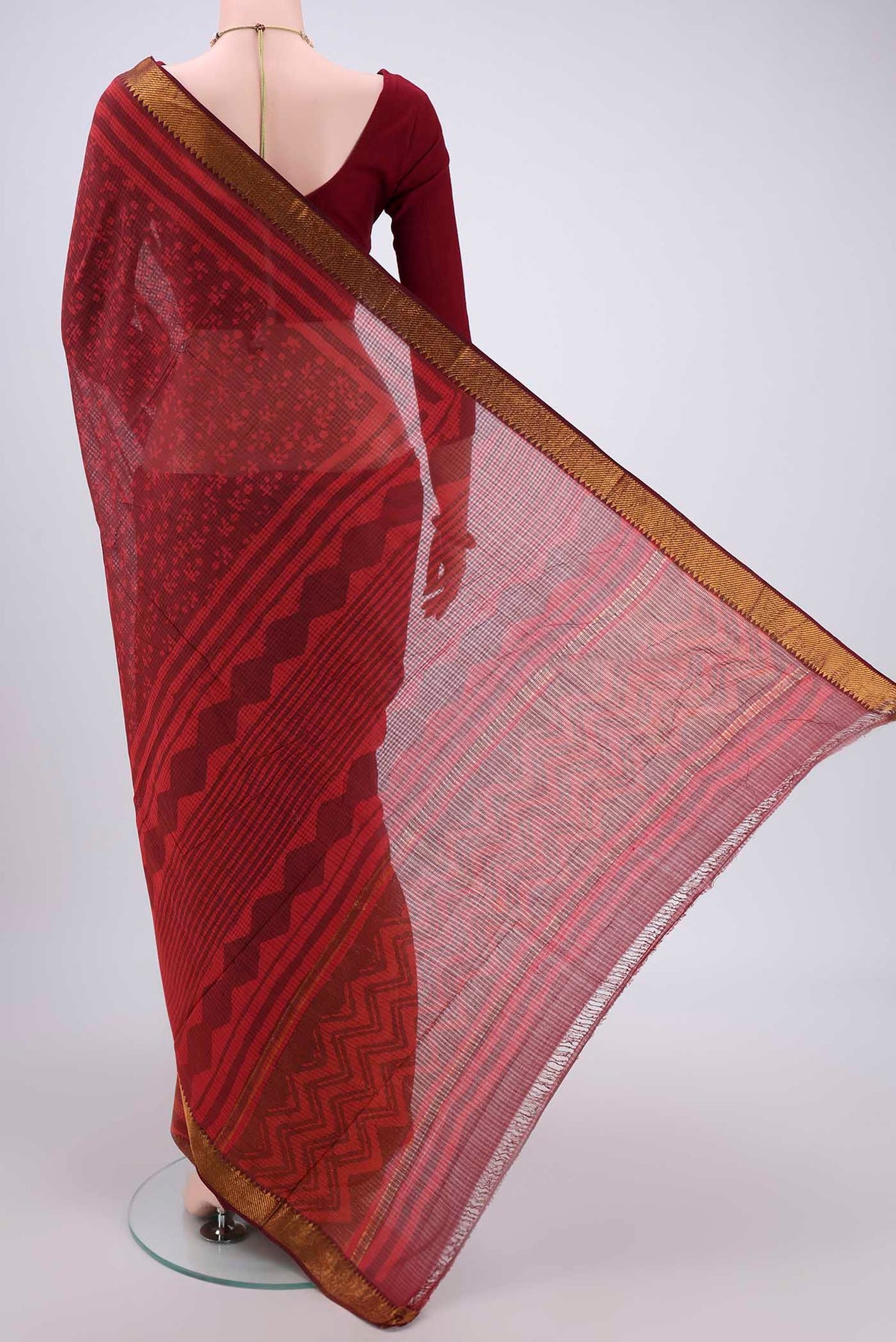 Flat view of Red Maheshwari Silk Cotton Saree with Batik Print on the body and Zari Border. 