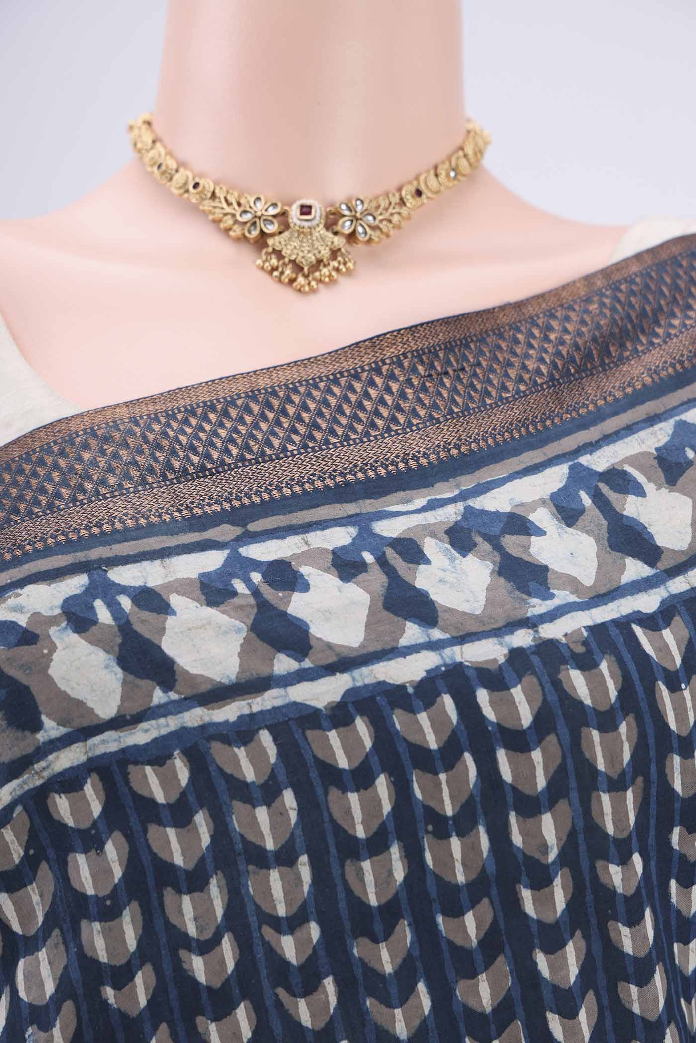 Border image of Indigo Maheshwari Silk Cotton Saree with Batik Print on the body and Zari Border. 