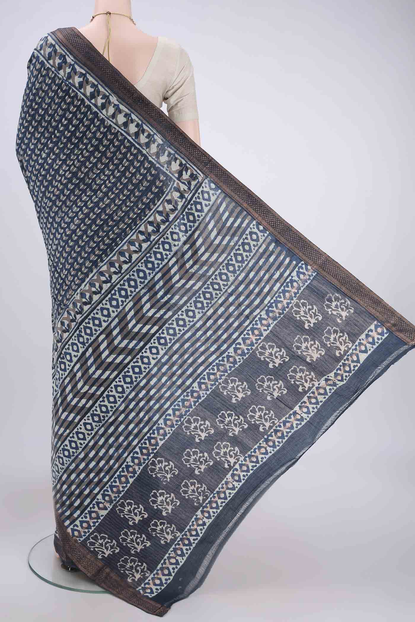 Flat view of Indigo Maheshwari Silk Cotton Saree with Batik Print on the body and Zari Border. 