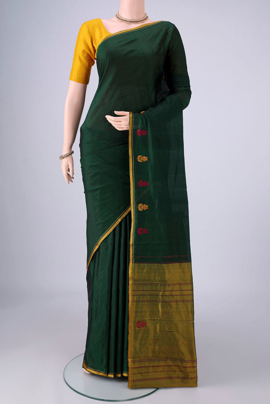Bottle Green Kanchipuram Silk Saree with Plain Body and Thread Border.  displayed on a mannequin