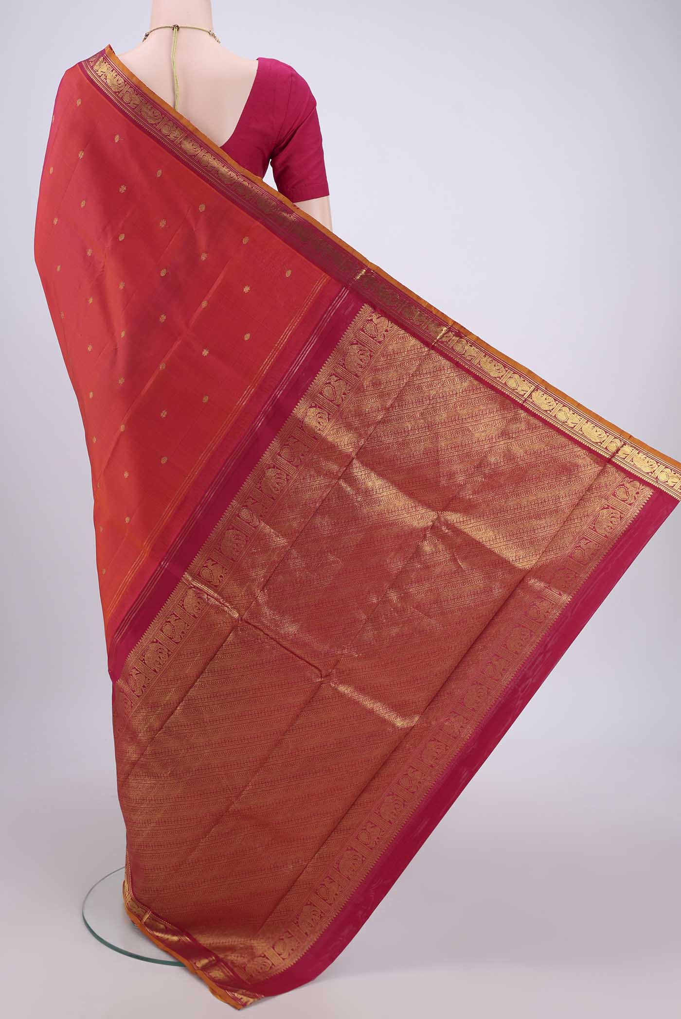 Flat view of Orange Kanchipuram Silk Saree with Plain Body and Zari Border. 