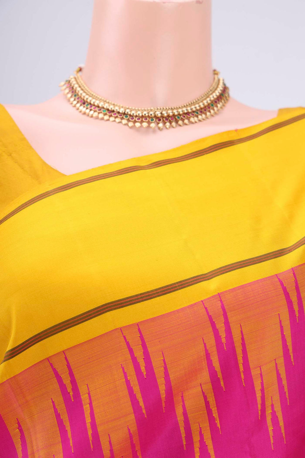 Border image of Rani Pink Kanjivaram Saree with Plain Body and Temple Border. 