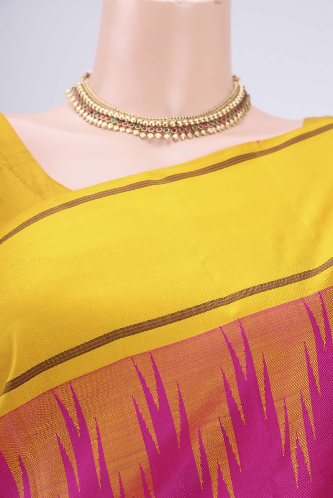 Border image of Rani Pink Kanjivaram Saree with Plain Body and Temple Border. 