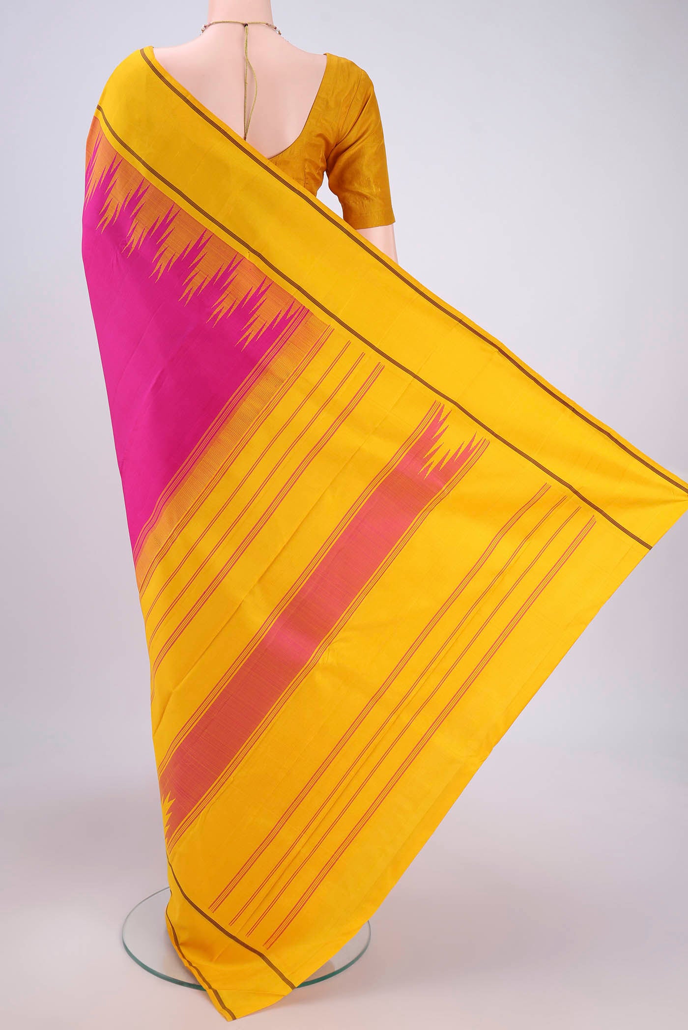 Flat view of Rani Pink Kanjivaram Saree with Plain Body and Temple Border. 