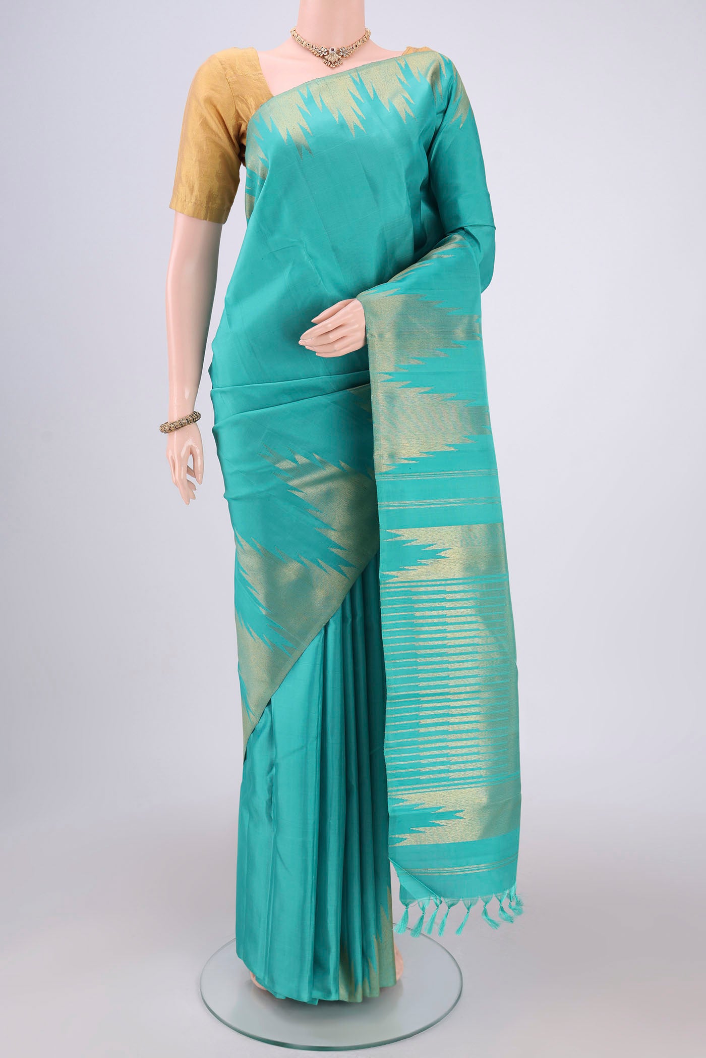 Sea Green Dual Tone Kanchipuram Silk Saree with Plain Body and Temple Border.  displayed on a mannequin