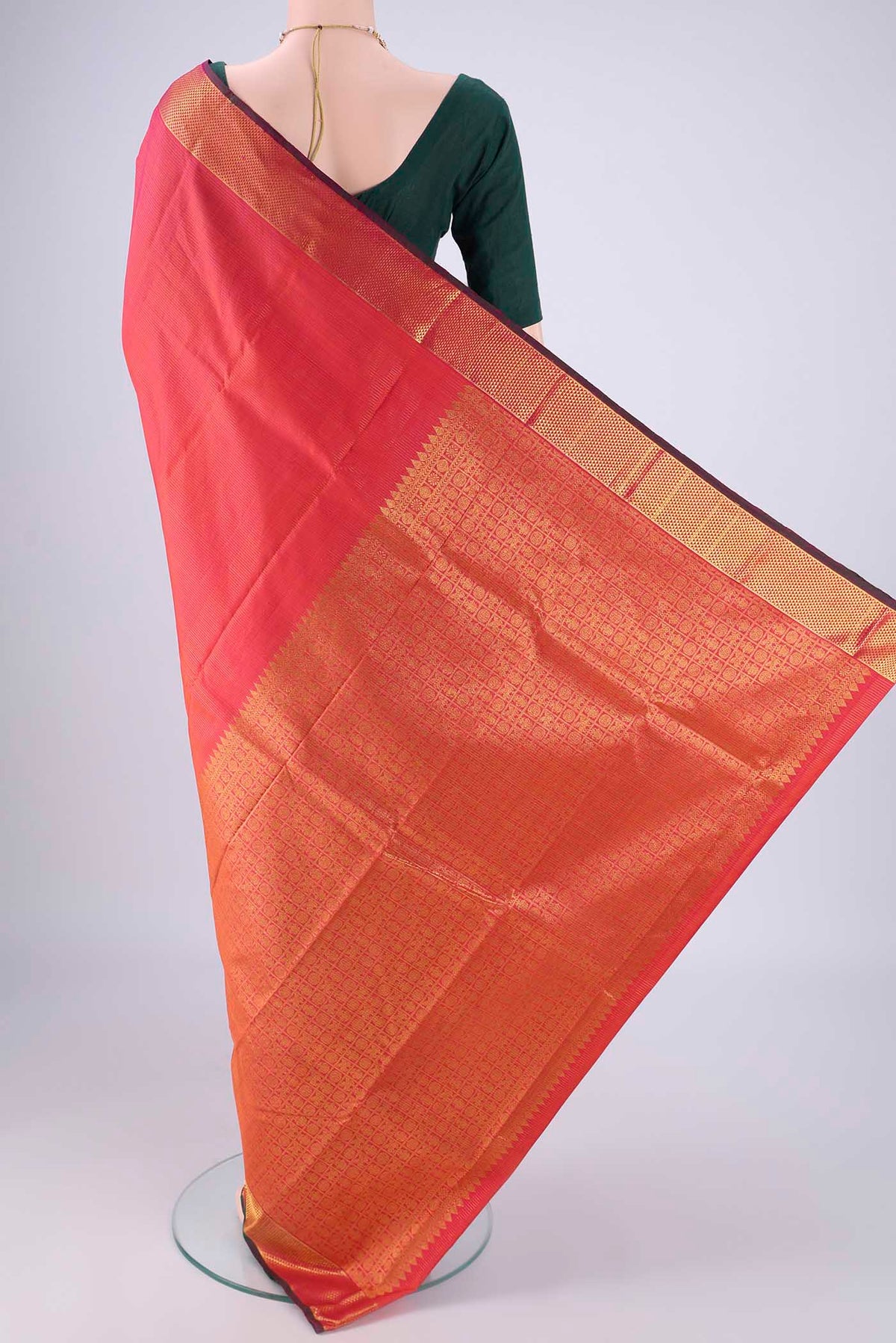Flat view of Coral Dual Tone Kanjivaram Silk Saree with Stripes on the body and Zari Border. 