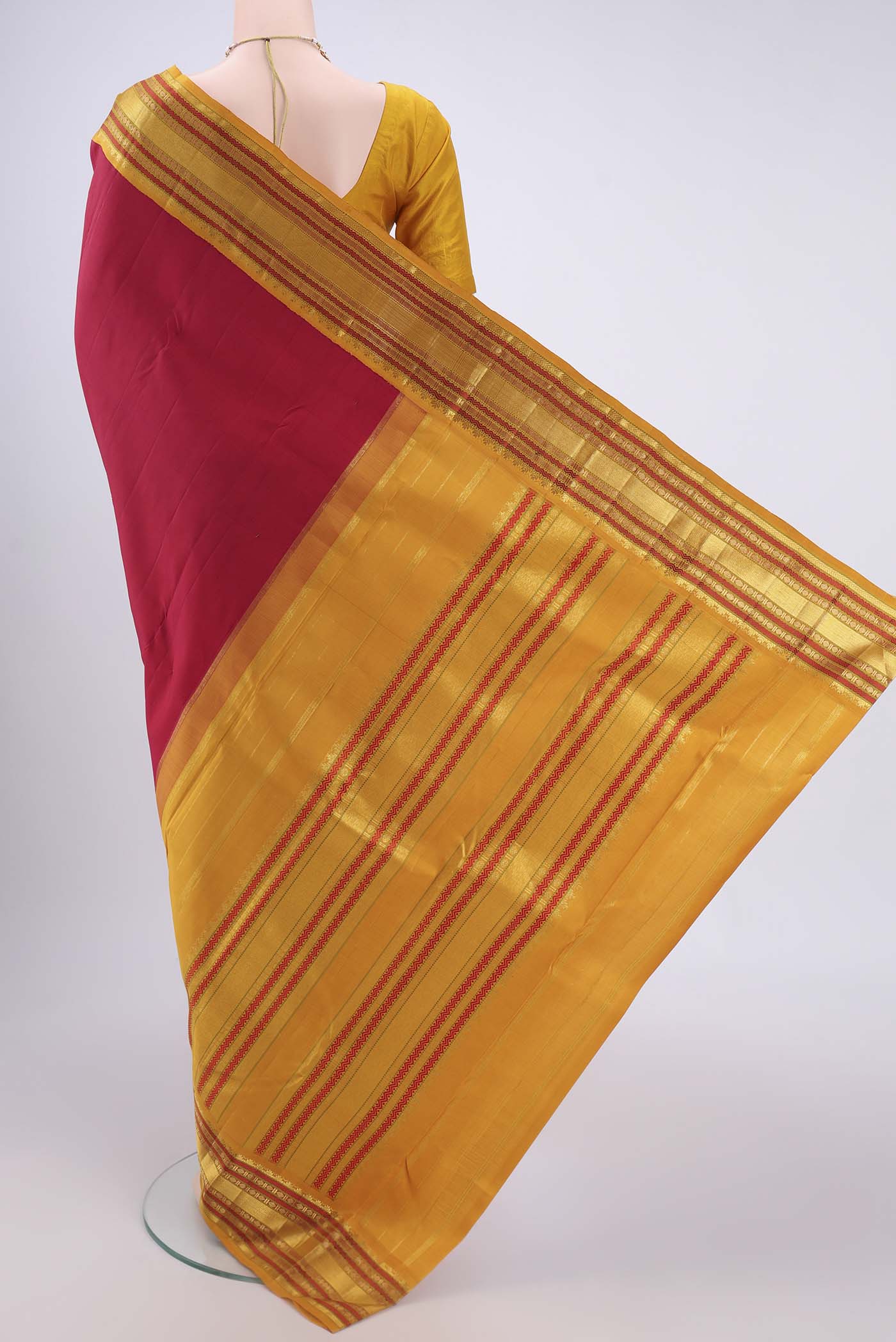 Flat view of Pure Silk Pure Zari Maroon Kanjivaram Saree with Plain Body and Zari Border. 