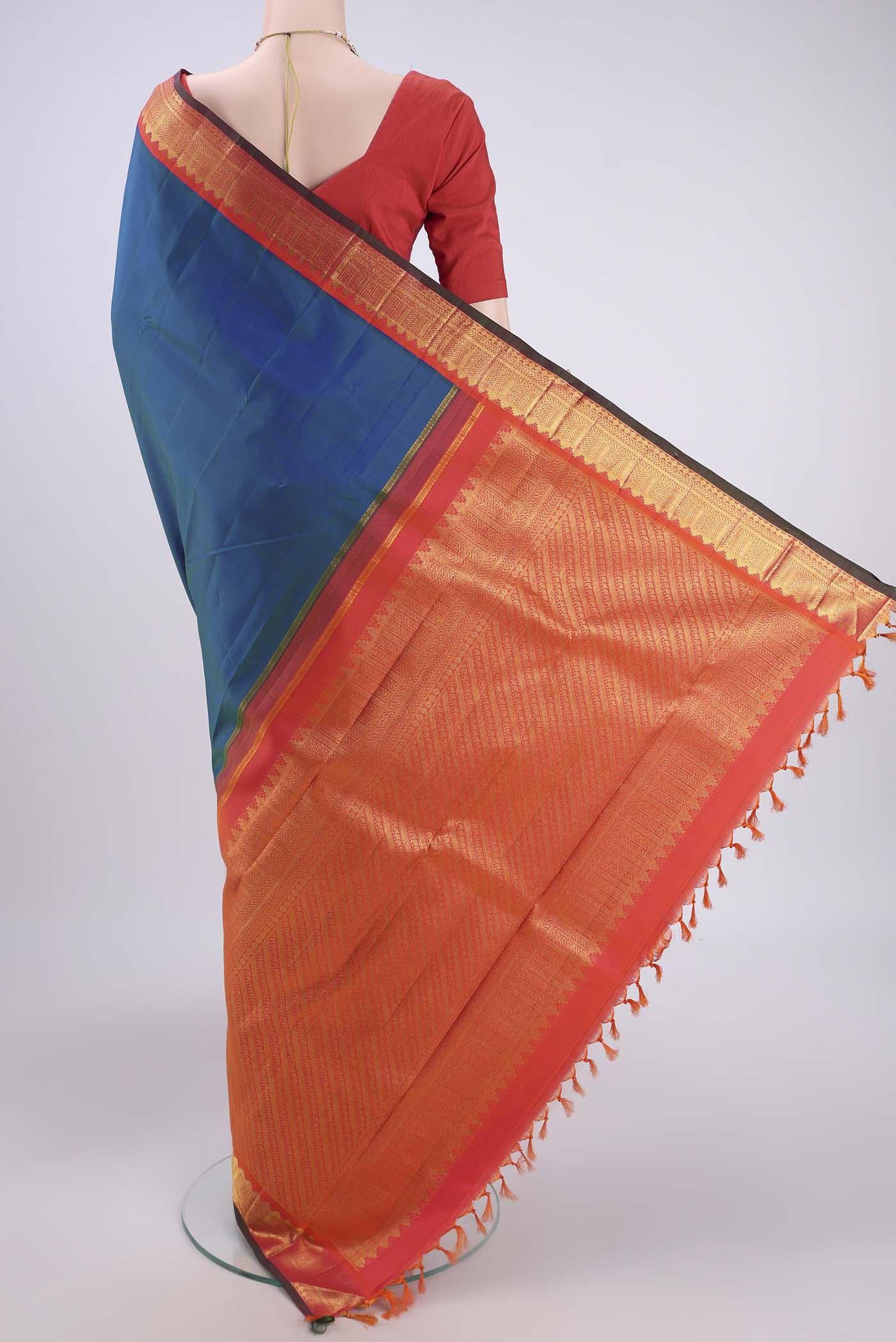 Flat view of Pure Silk Pure Zari Peacock Blue Kanjivaram Saree with Plain Body and Zari Border. 