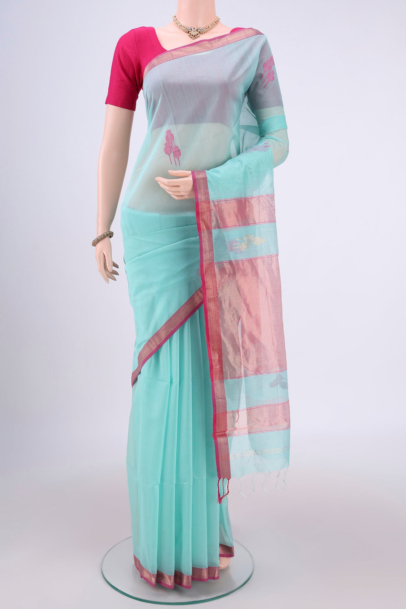 Turquoise Maheshwari Silk Cotton Saree with Zari Butta on the body and Zari Border.  displayed on a mannequin