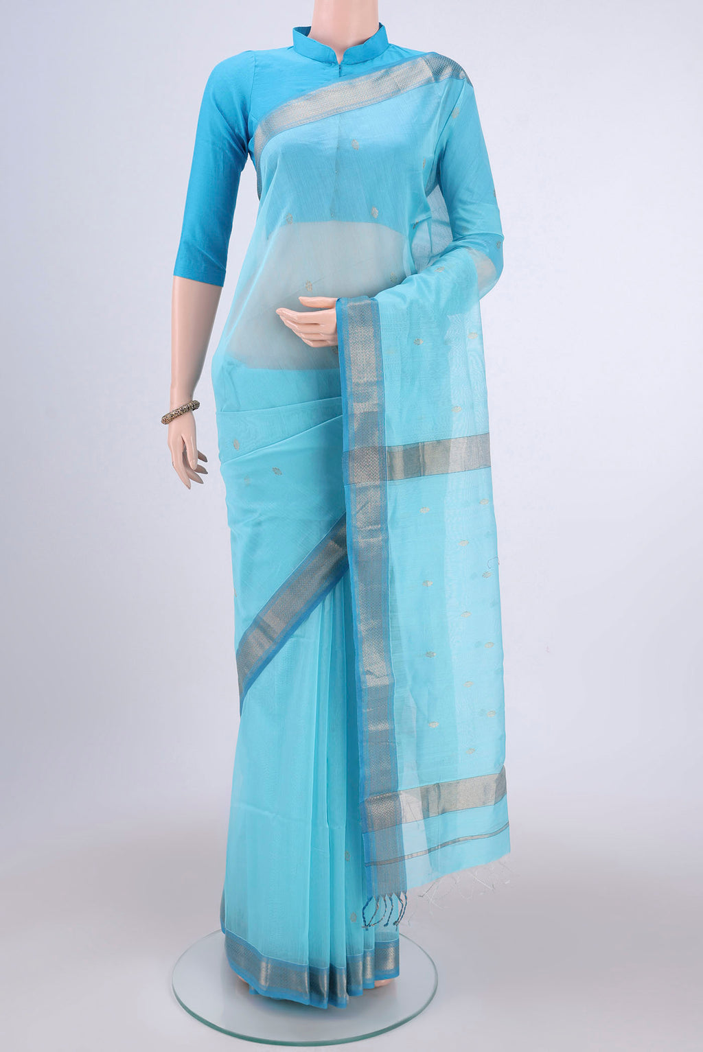 Sky Blue Maheshwari Silk Cotton Saree with Zari Butta on the body and Zari Border.  displayed on a mannequin