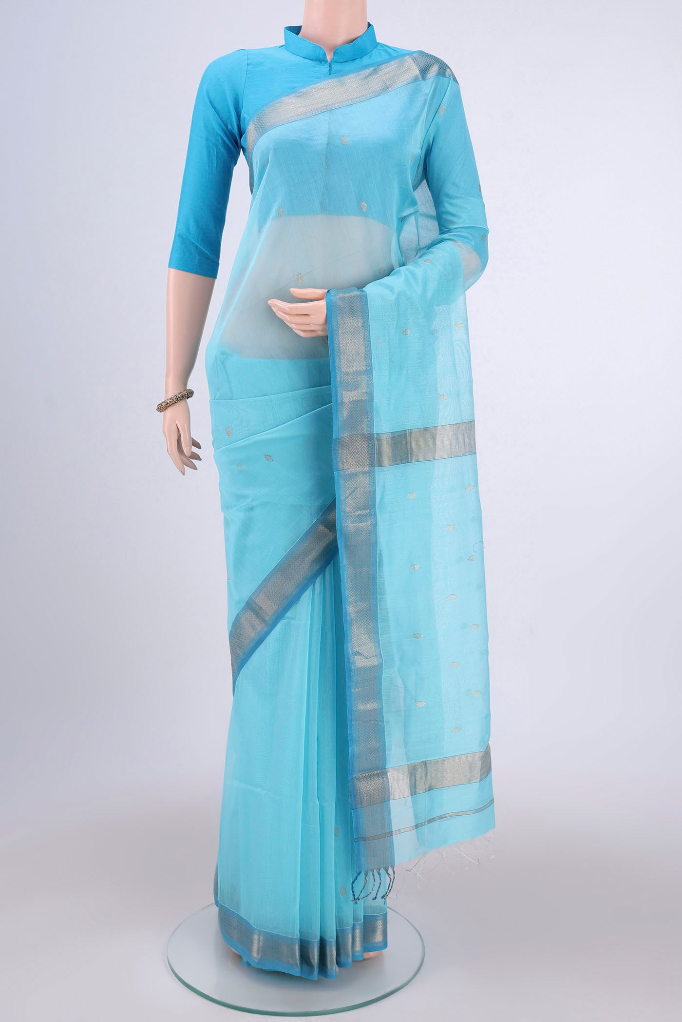 Sky Blue Maheshwari Silk Cotton Saree with Zari Butta on the body and Zari Border.  displayed on a mannequin