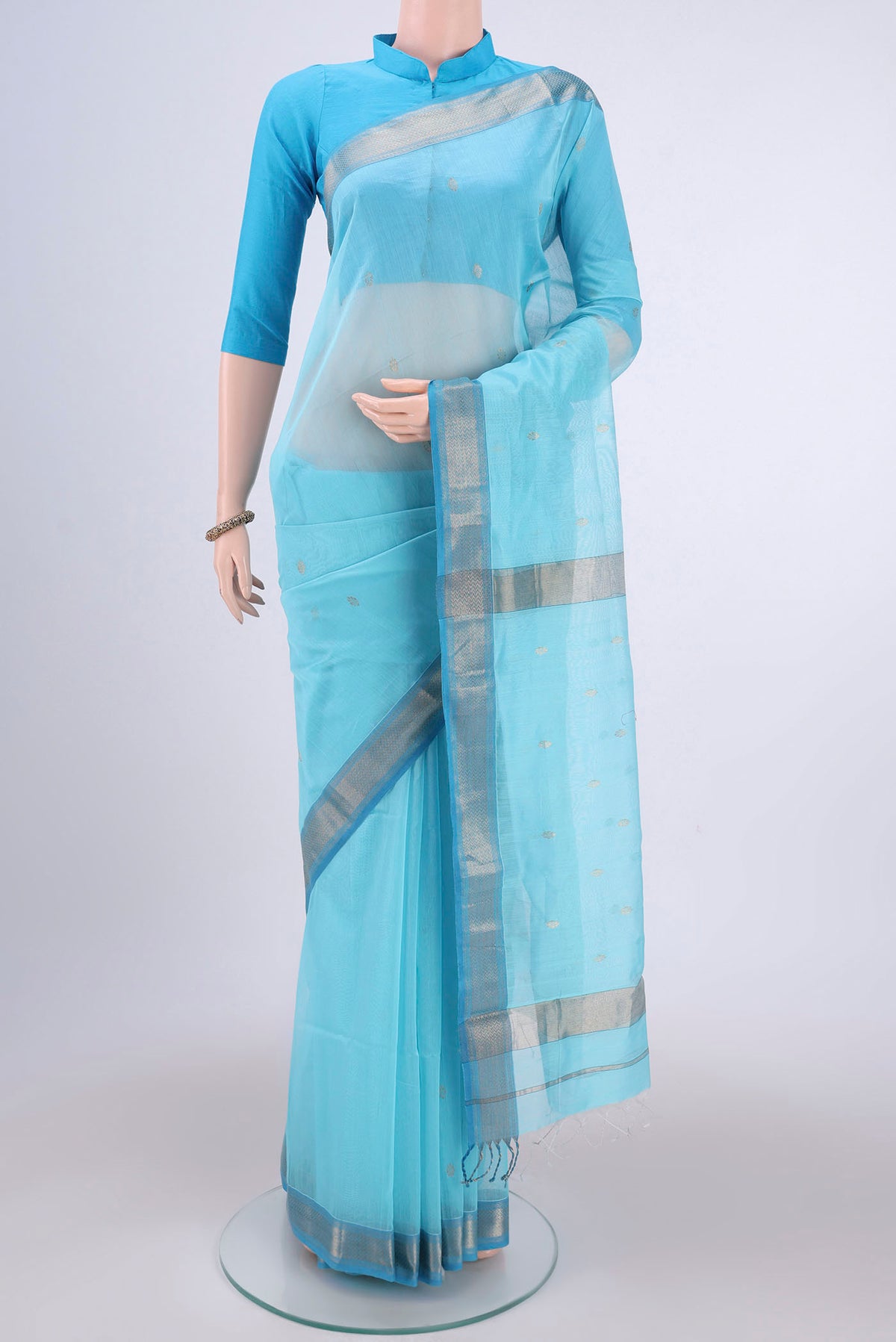 Sky Blue Maheshwari Silk Cotton Saree with Zari Butta on the body and Zari Border.  displayed on a mannequin