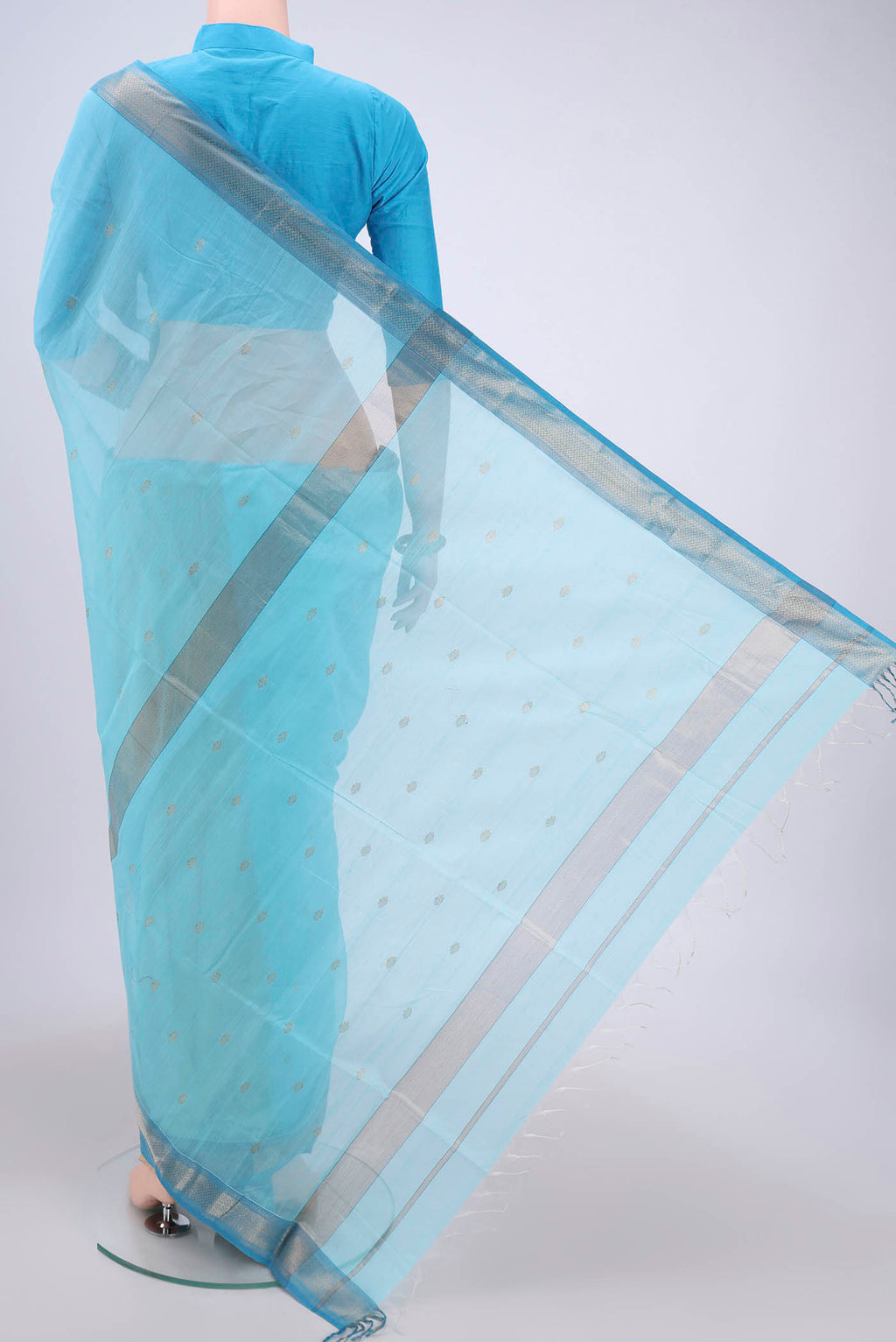 Flat view of Sky Blue Maheshwari Silk Cotton Saree with Zari Butta on the body and Zari Border. 
