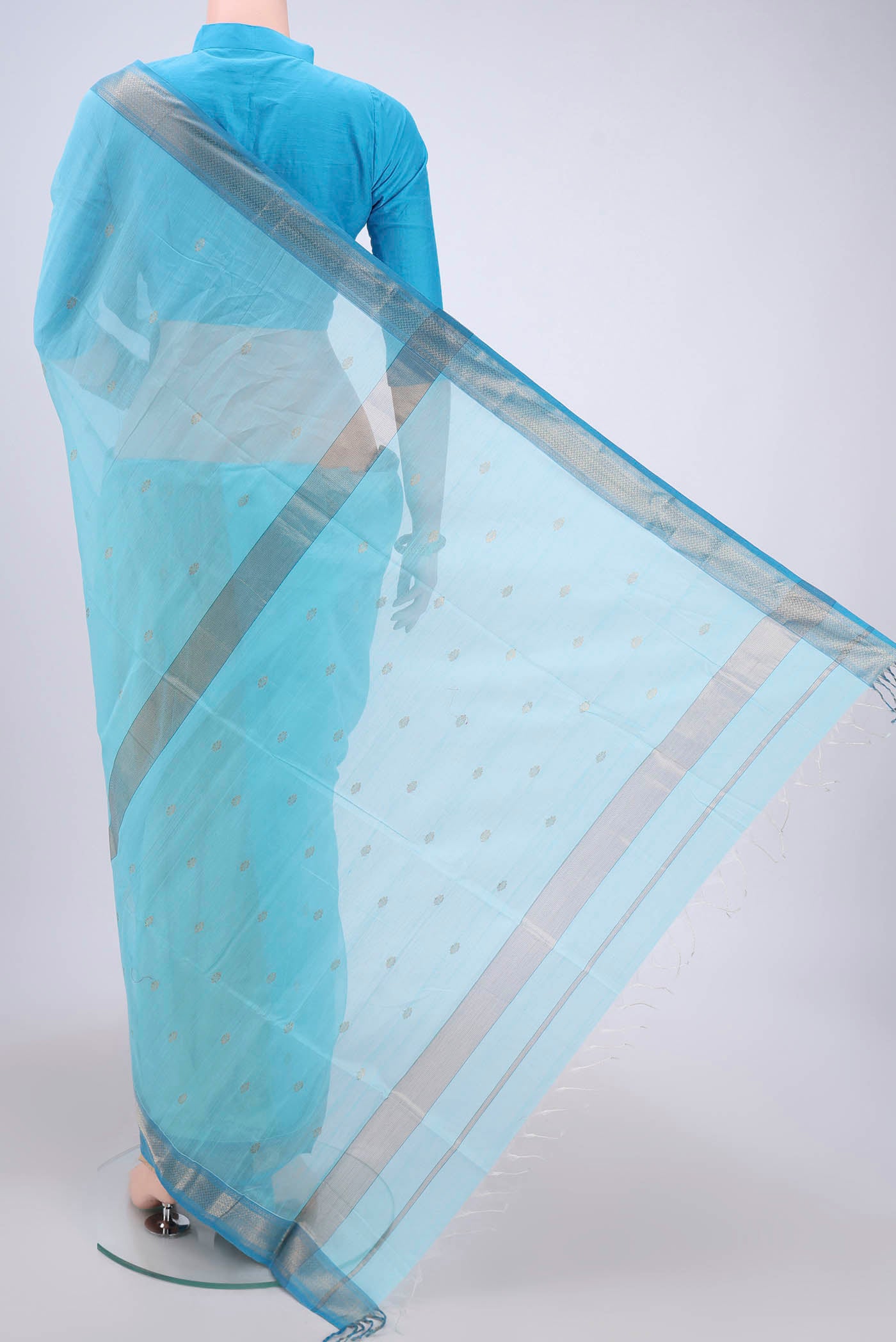 Flat view of Sky Blue Maheshwari Silk Cotton Saree with Zari Butta on the body and Zari Border. 