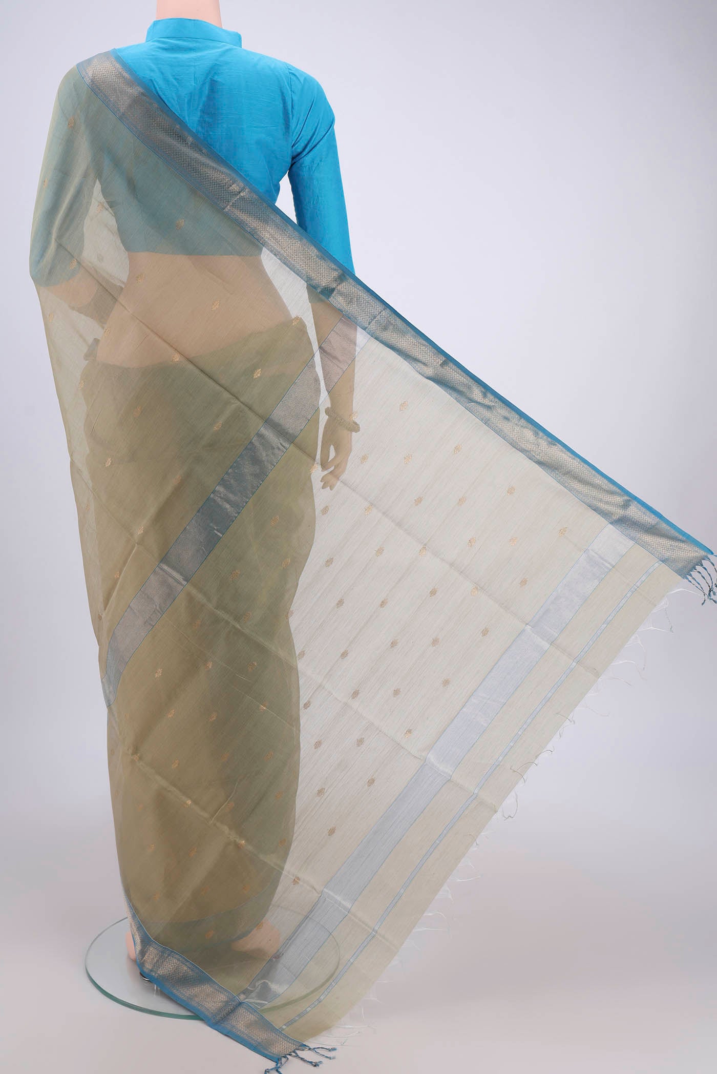 Flat view of Sage Green Maheshwari Silk Cotton Saree with Zari Butta on the body and Zari Border. 