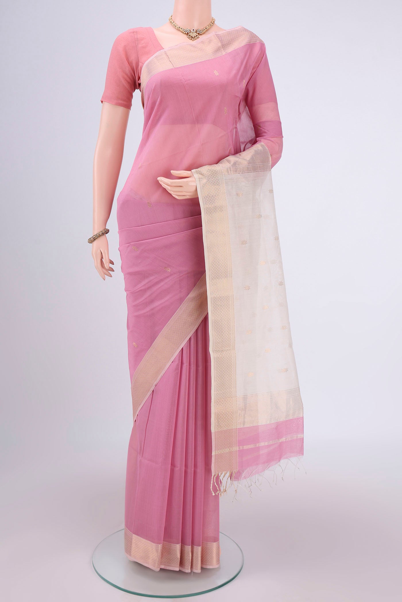 Pink Maheshwari Silk Cotton Saree with Zari Butta on the body and Zari Border.  displayed on a mannequin