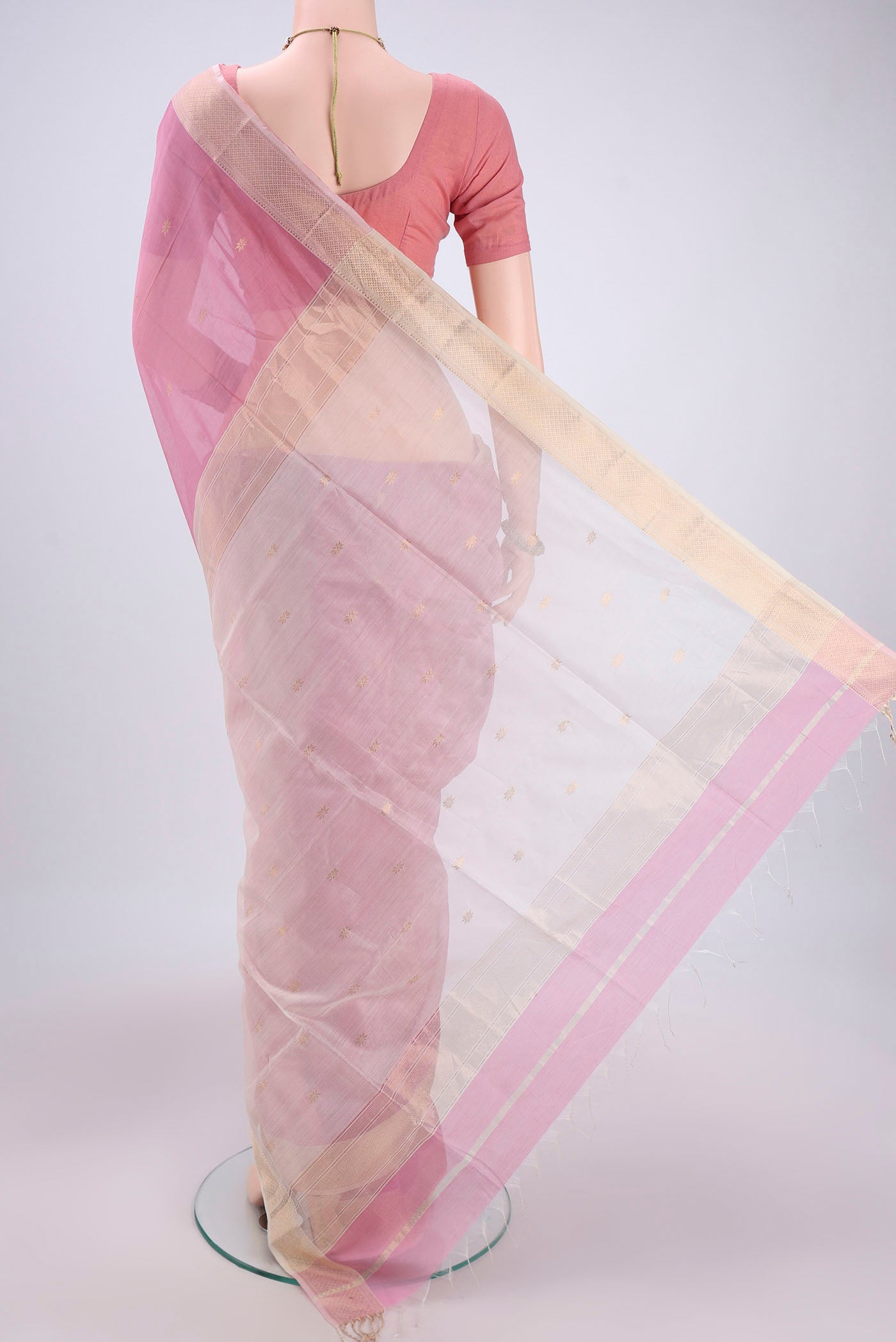 Flat view of Pink Maheshwari Silk Cotton Saree with Zari Butta on the body and Zari Border. 