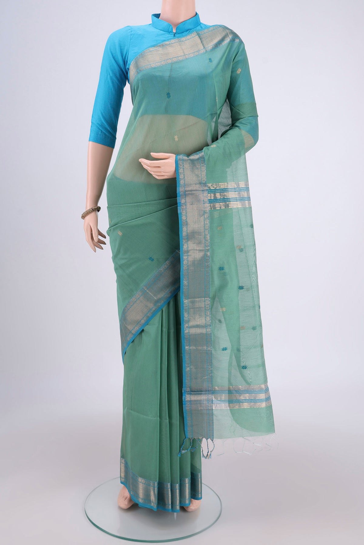 Mint Green Maheshwari Silk Cotton Saree with Plain Body and Zari Border.  displayed on a mannequin