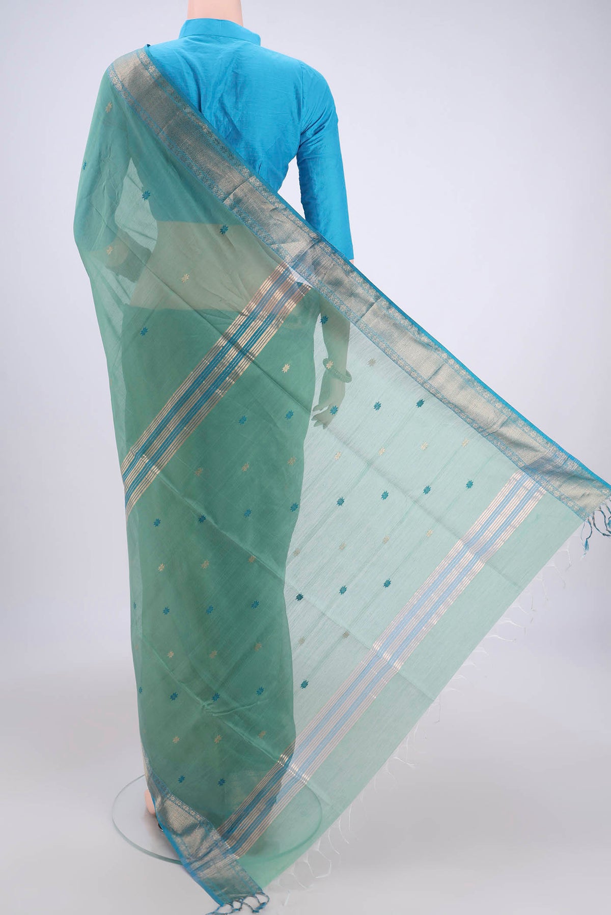 Flat view of Mint Green Maheshwari Silk Cotton Saree with Plain Body and Zari Border. 