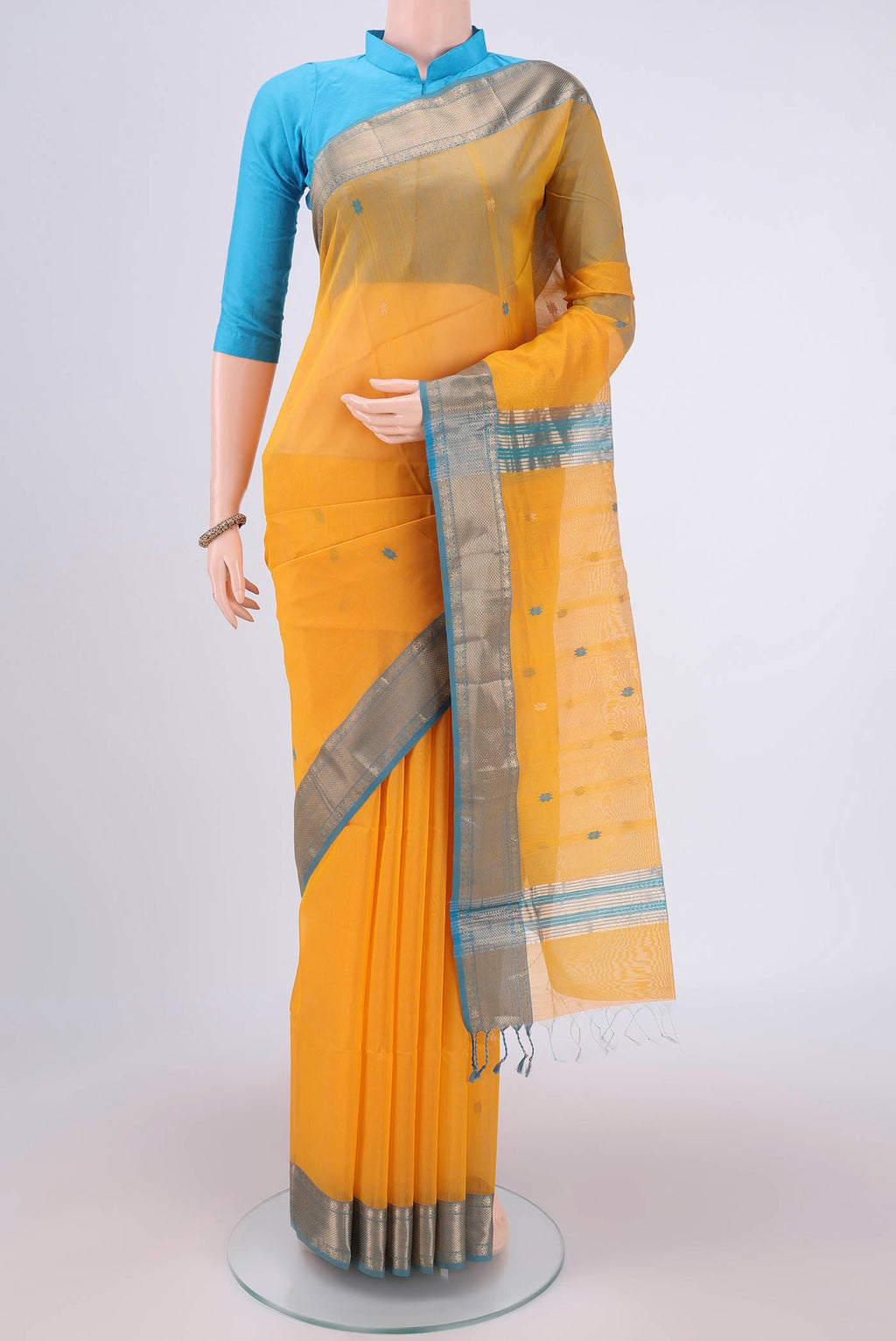 Yellow Maheshwari Silk Cotton Saree with Zari Butta on the body and Zari Border.  displayed on a mannequin