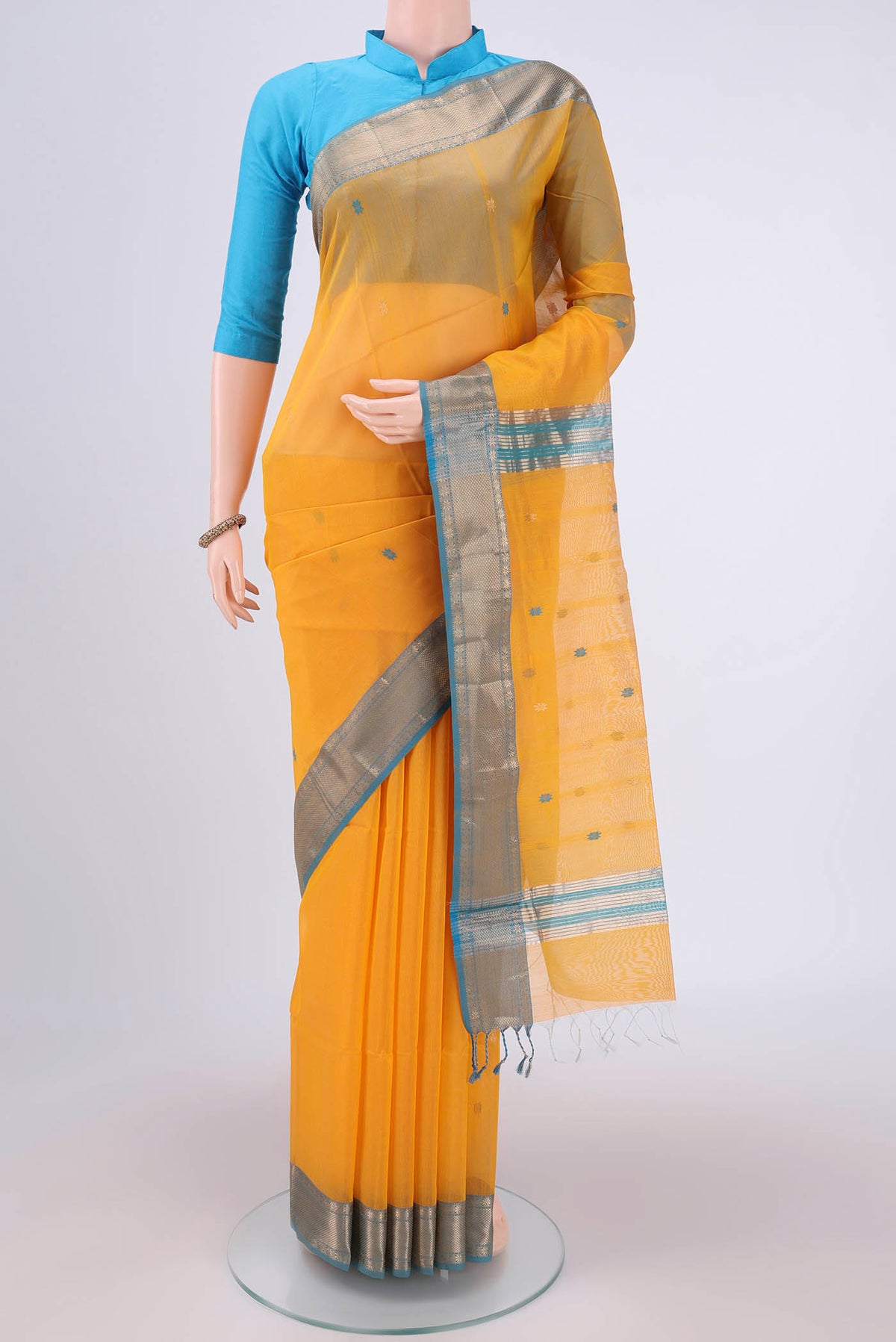 Yellow Maheshwari Silk Cotton Saree with Zari Butta on the body and Zari Border.  displayed on a mannequin