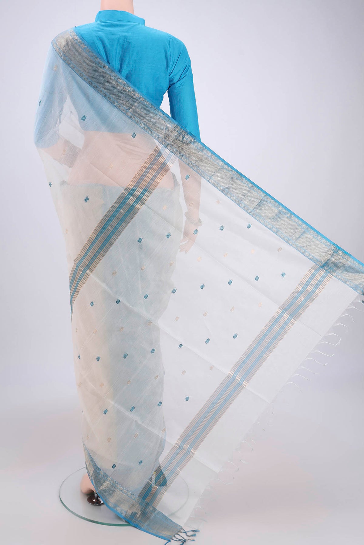 Flat view of White Maheshwari Silk Cotton Saree with Plain Body and Zari Border. 