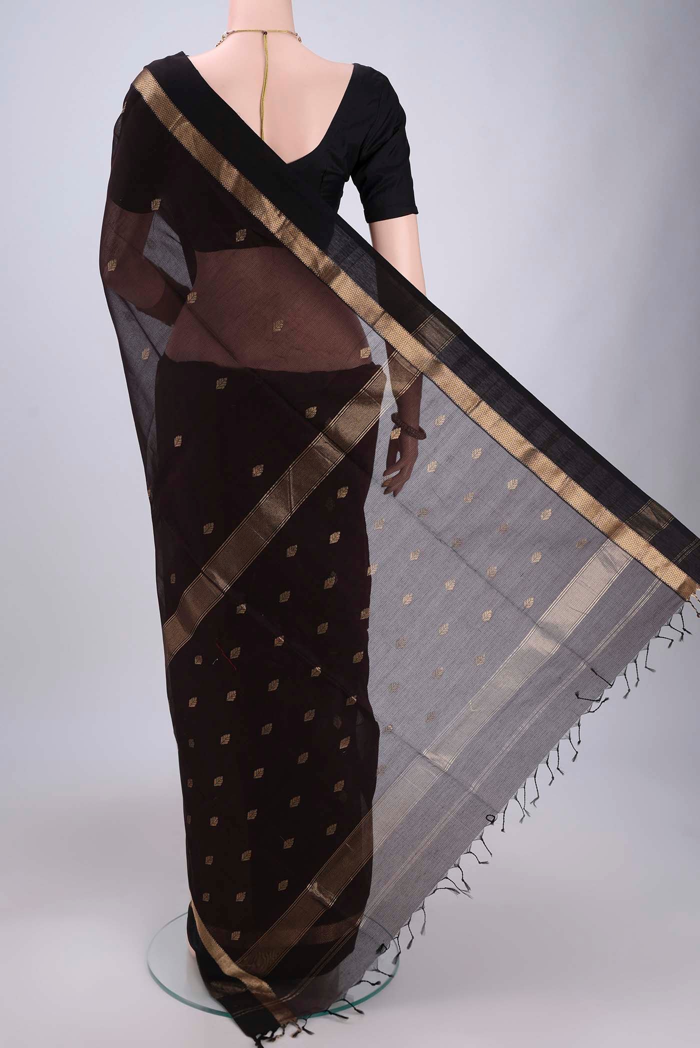 Flat view of Brown Maheshwari Silk Cotton Saree with Zari Butta on the body and Zari Border. 
