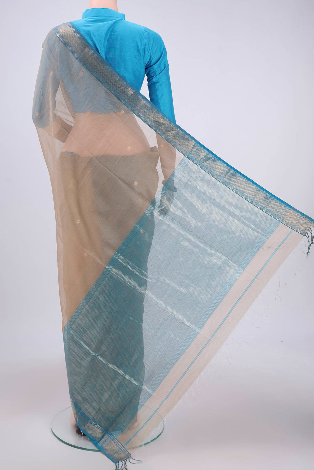 Flat view of Dark Beige Maheshwari Silk Cotton Saree with Zari And Thread Butta on the body and Zari Border. 