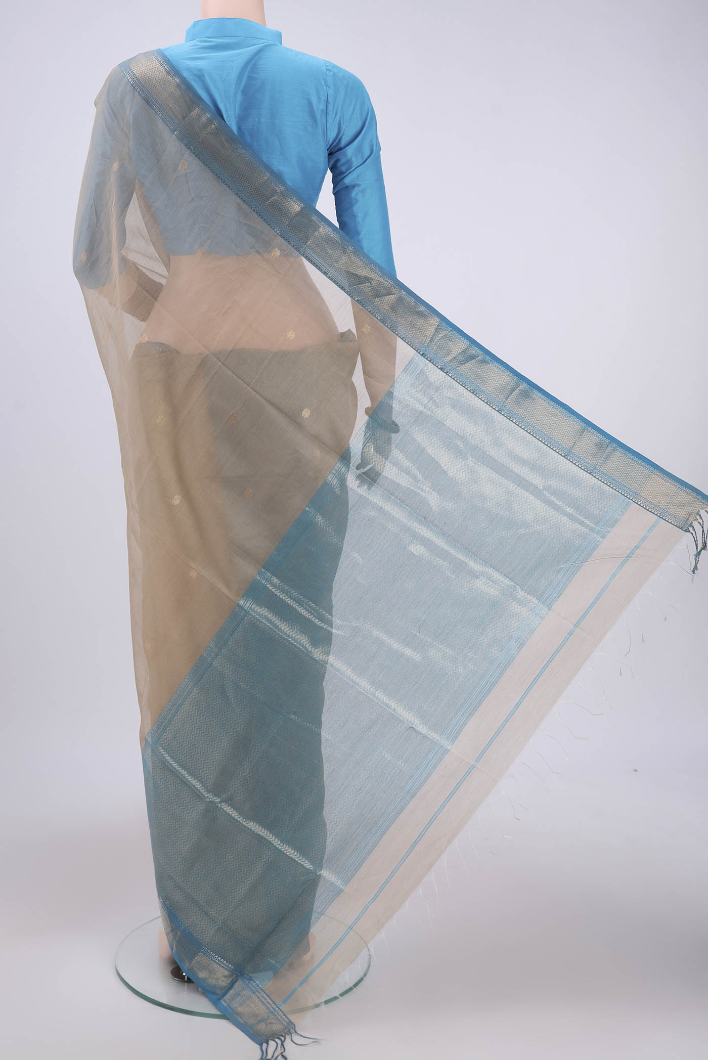 Flat view of Dark Beige Maheshwari Silk Cotton Saree with Zari And Thread Butta on the body and Zari Border. 