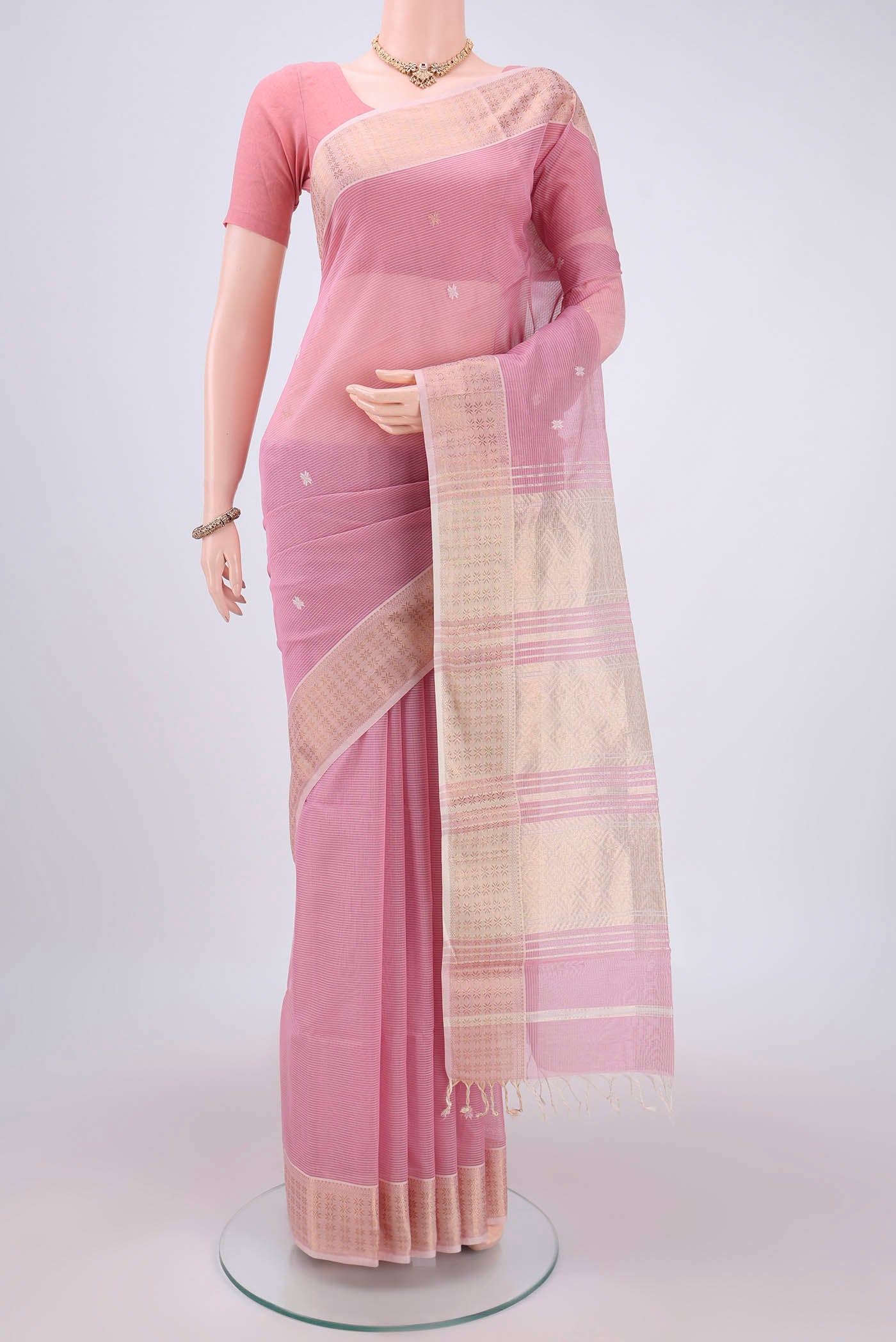 Rose pink Maheshwari Silk Cotton Saree with Zari And Thread Butta on the body and Zari And Thread Border.  displayed on a mannequin