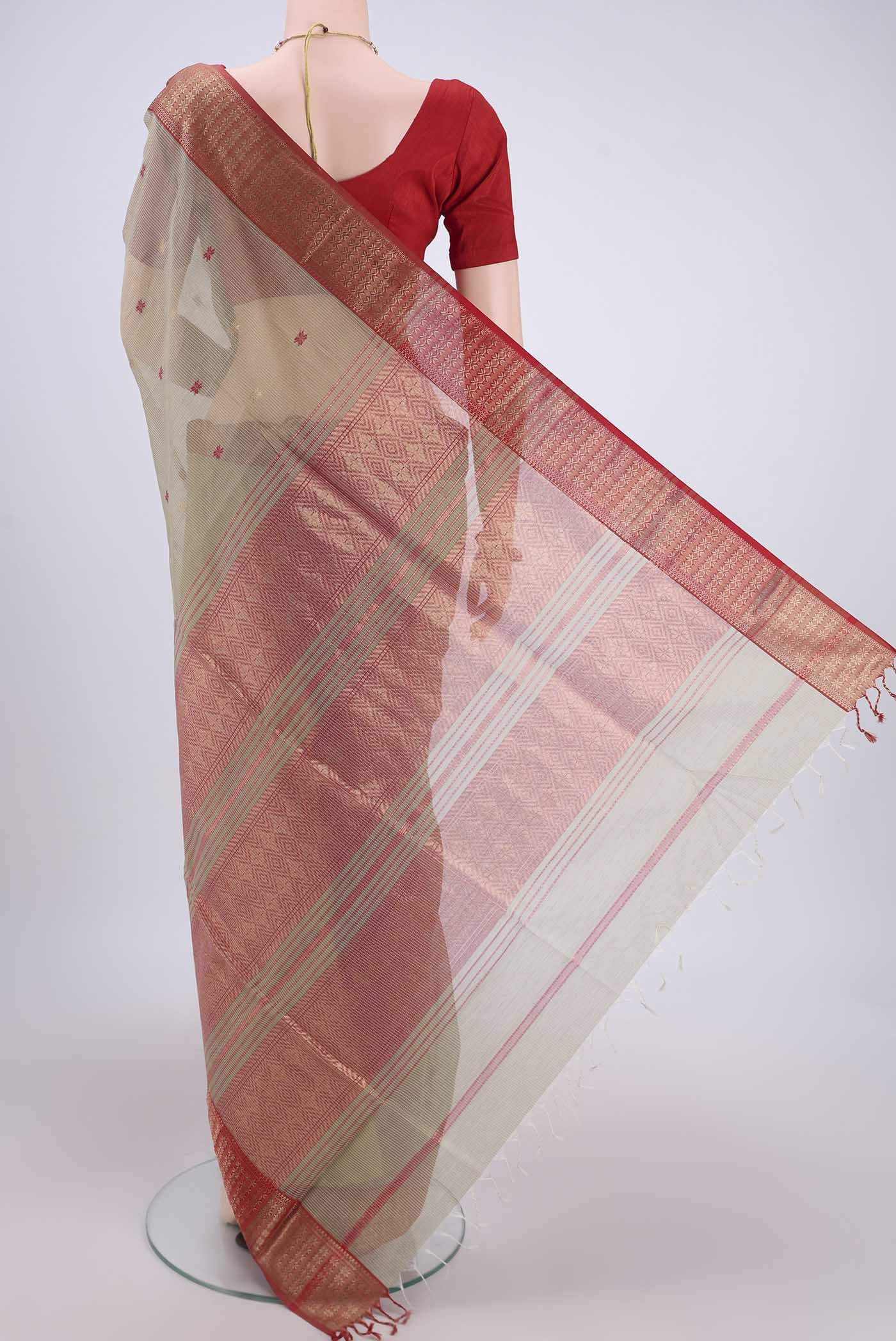 Flat view of Pista Green Maheshwari Silk Cotton Saree with Zari And Thread Butta on the body and Zari Border. 