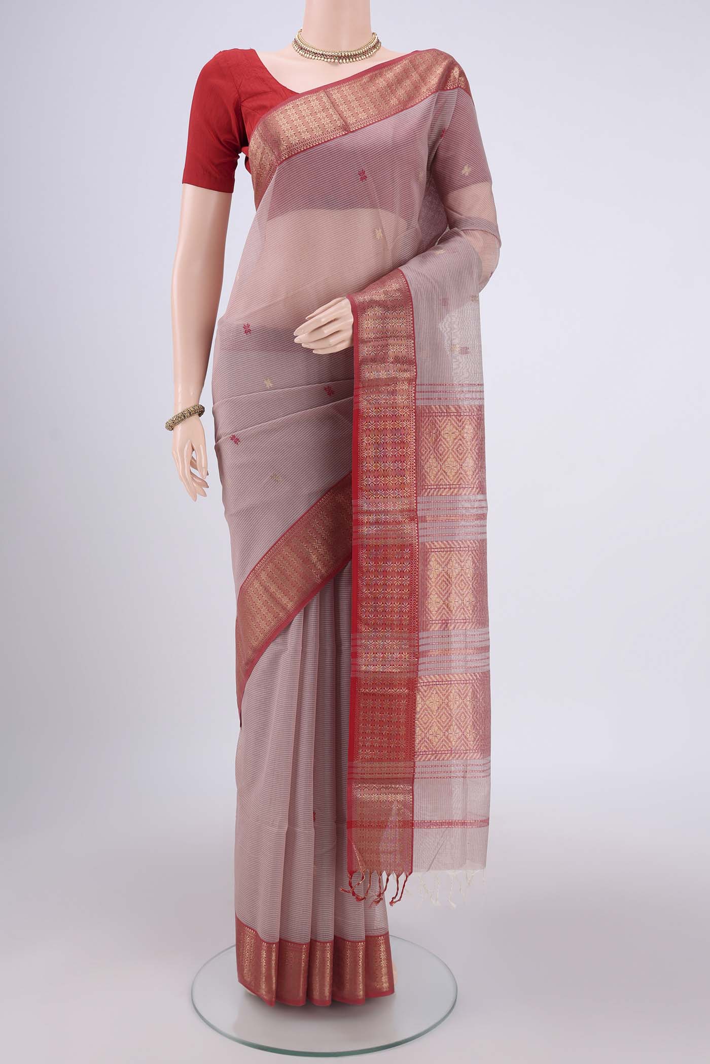 Coral Maheshwari Silk Cotton Saree with Zari Butta on the body and Zari Border.  displayed on a mannequin