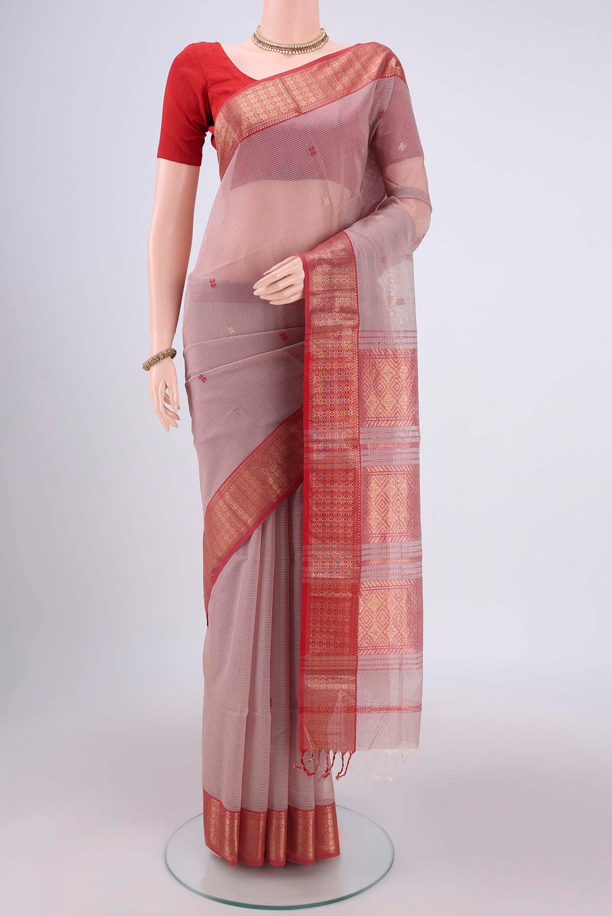 Coral Maheshwari Silk Cotton Saree with Zari Butta on the body and Zari Border.  displayed on a mannequin