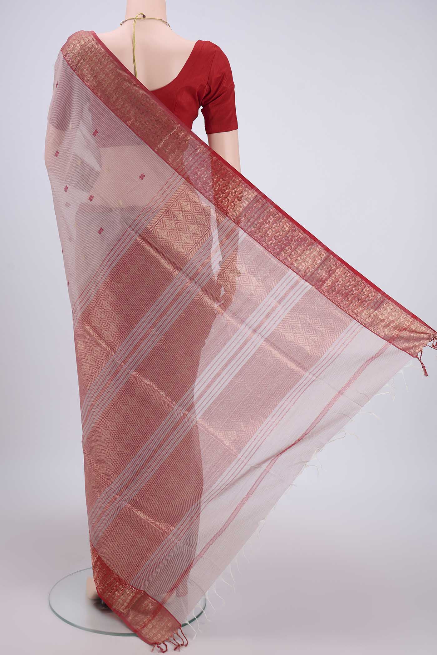 Flat view of Coral Maheshwari Silk Cotton Saree with Zari Butta on the body and Zari Border. 
