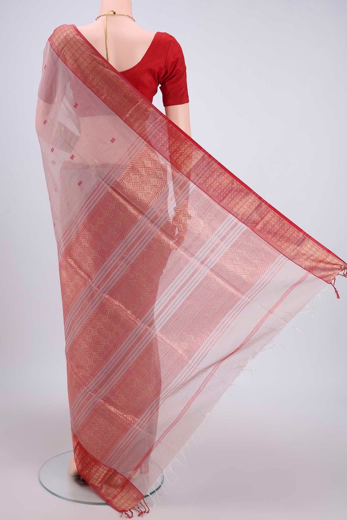 Flat view of Coral Maheshwari Silk Cotton Saree with Zari Butta on the body and Zari Border. 