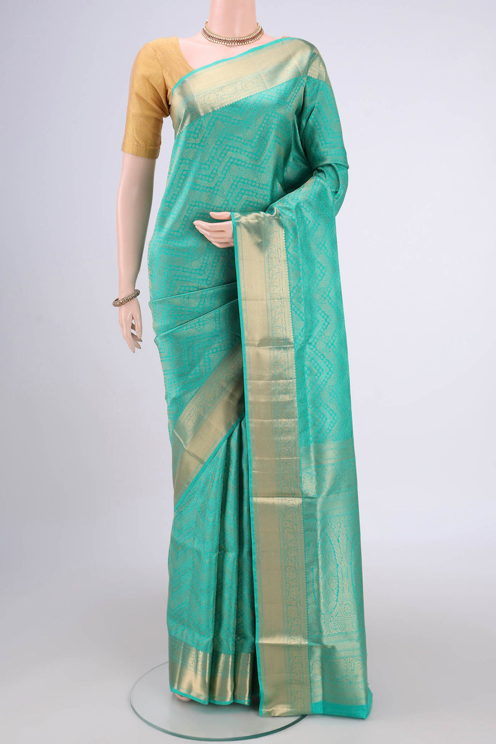Sea Green Soft Silk Saree with Zari Brocade on the body and Zari Border.  displayed on a mannequin