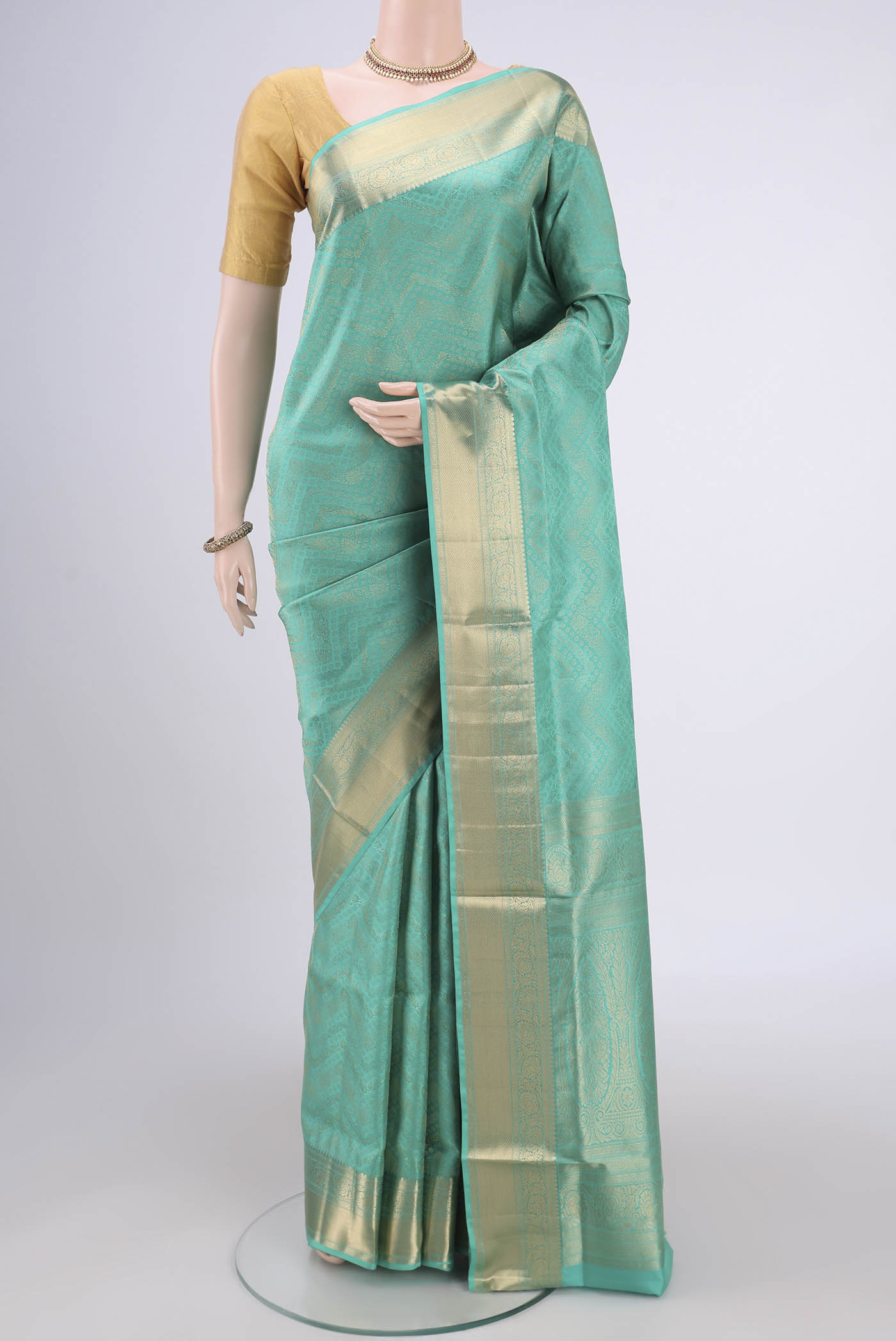 Sea Green Soft Silk Saree with Zari Brocade on the body and Zari Border.  displayed on a mannequin