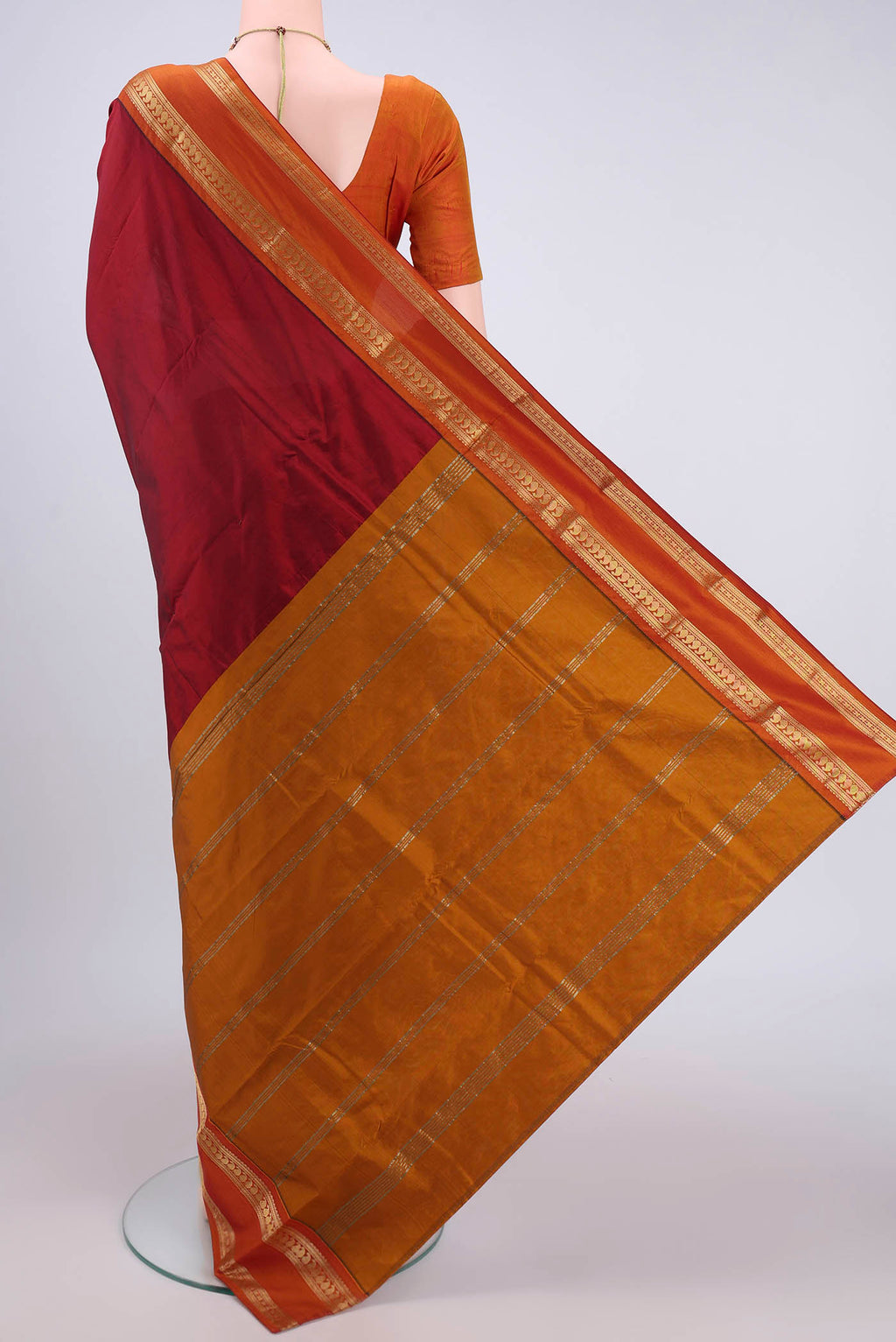 Flat view of Maroon Bangalore Silk Saree with Plain Body and Zari Border. 