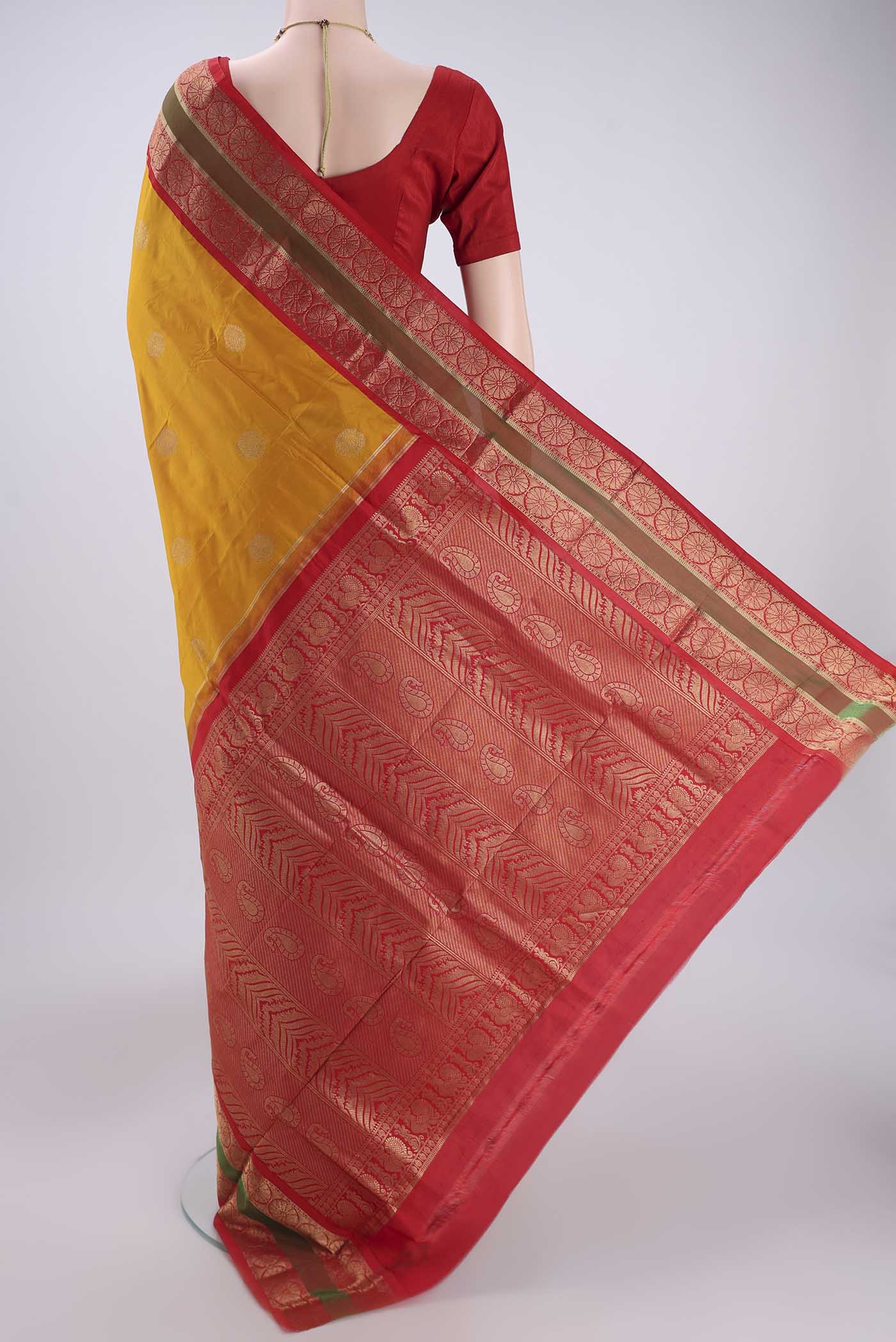 Flat view of Mustard Bangalore Silk Saree with Zari Butta on the body and Temple Border. 