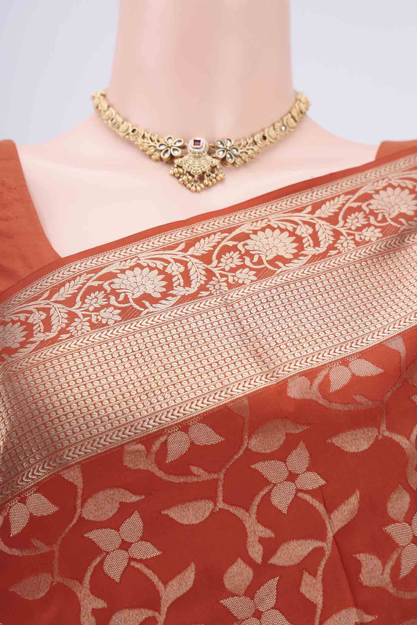 Border image of Rust Soft Silk Saree with Zari Brocade on the body and Zari Border. 