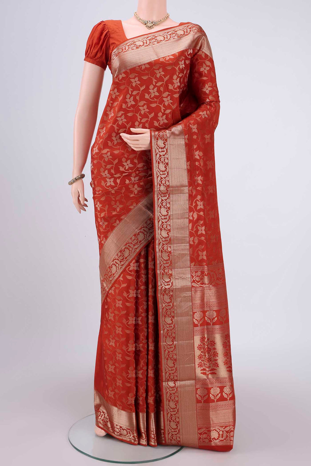 Rust Soft Silk Saree with Zari Brocade on the body and Zari Border.  displayed on a mannequin