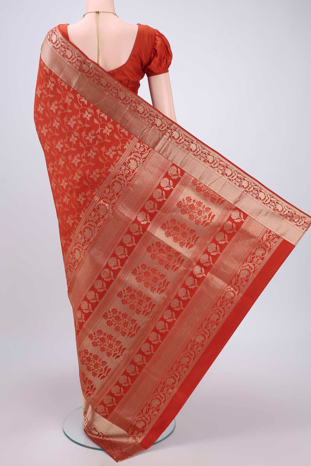 Flat view of Rust Soft Silk Saree with Zari Brocade on the body and Zari Border. 