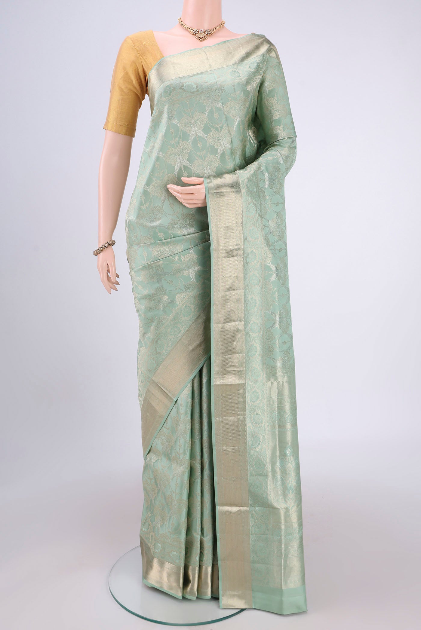 Sage Green Dual Tone Soft Silk Saree with Zari Brocade on the body and Zari Border.  displayed on a mannequin