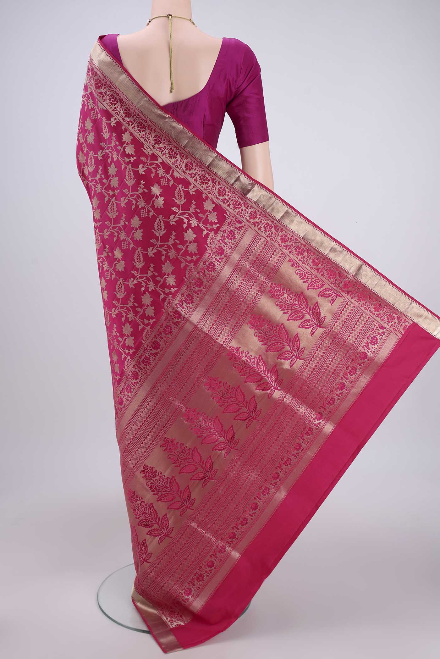 Flat view of Rani Pink Soft Silk Saree with Zari Brocade on the body and Zari Border. 